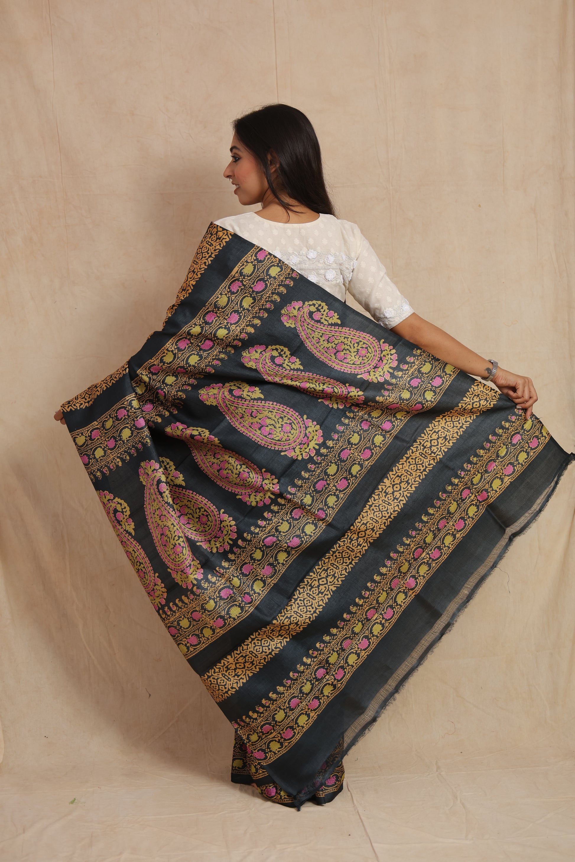 Full pallu display of black Tussar silk saree with intricate paisley and floral design
