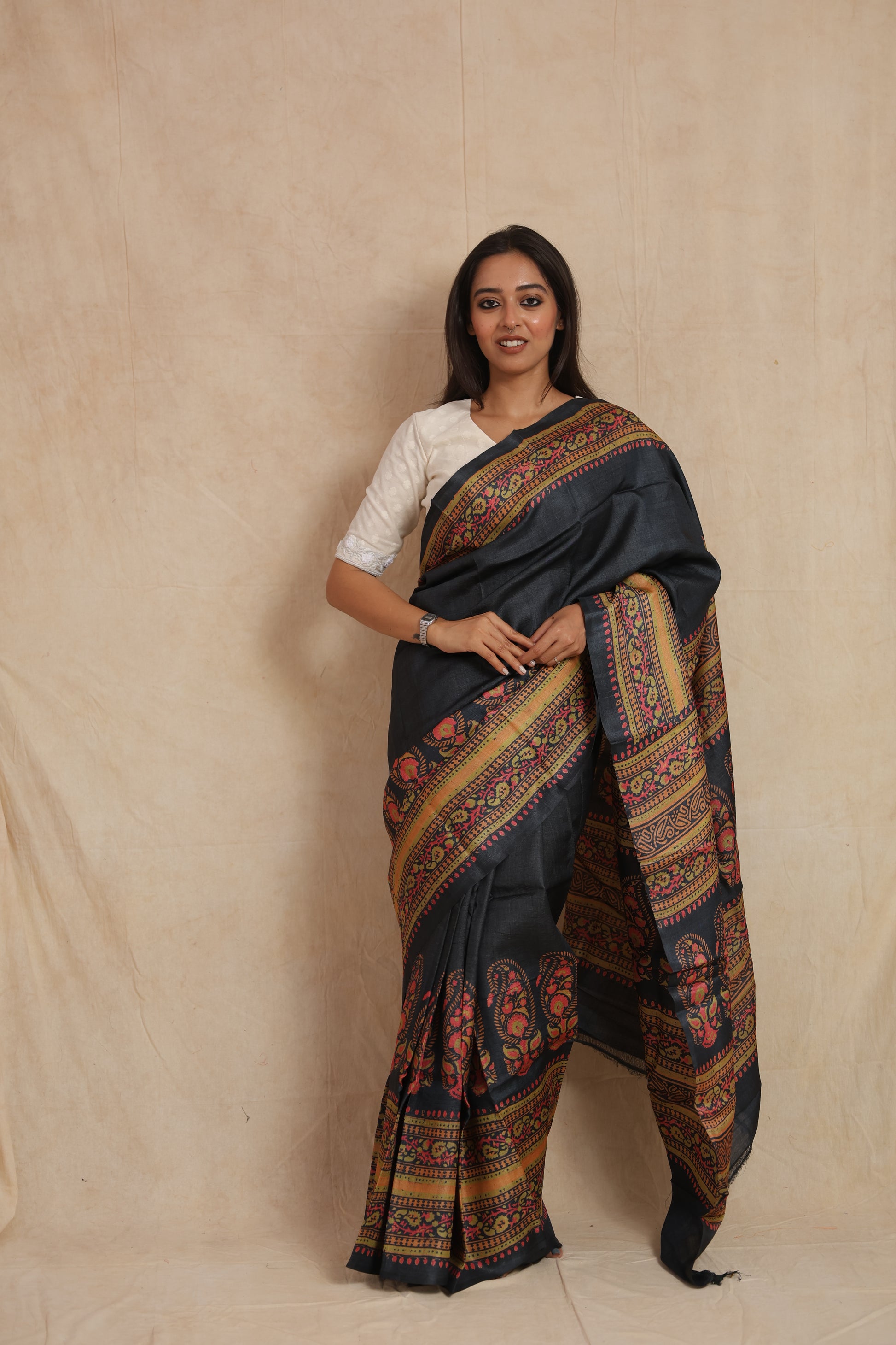 Handcrafted midnight zed black Batik Tussar silk saree with floral paisley border front view