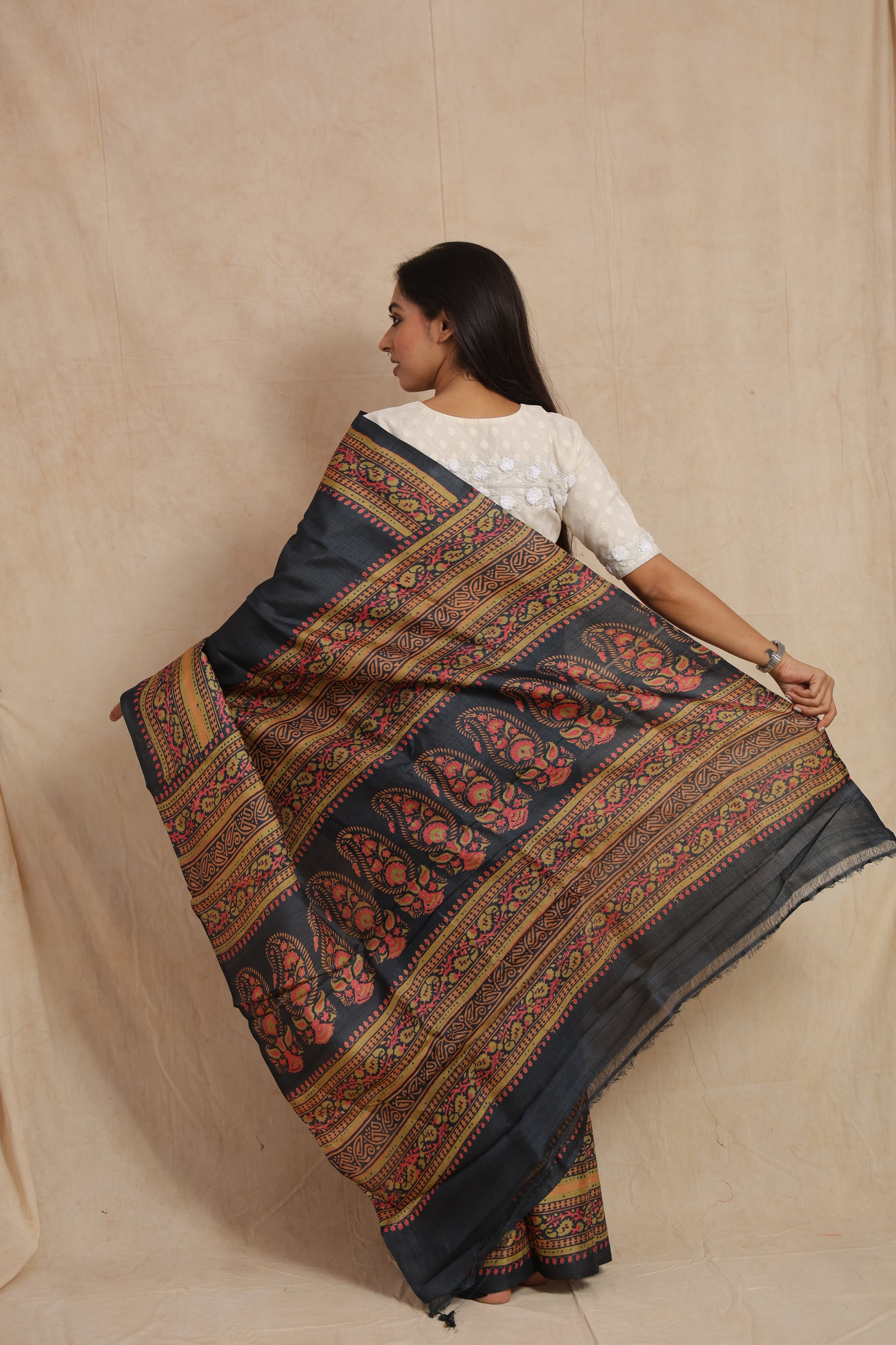 Full pallu display of midnight zed black Batik Tussar silk saree with floral patterns