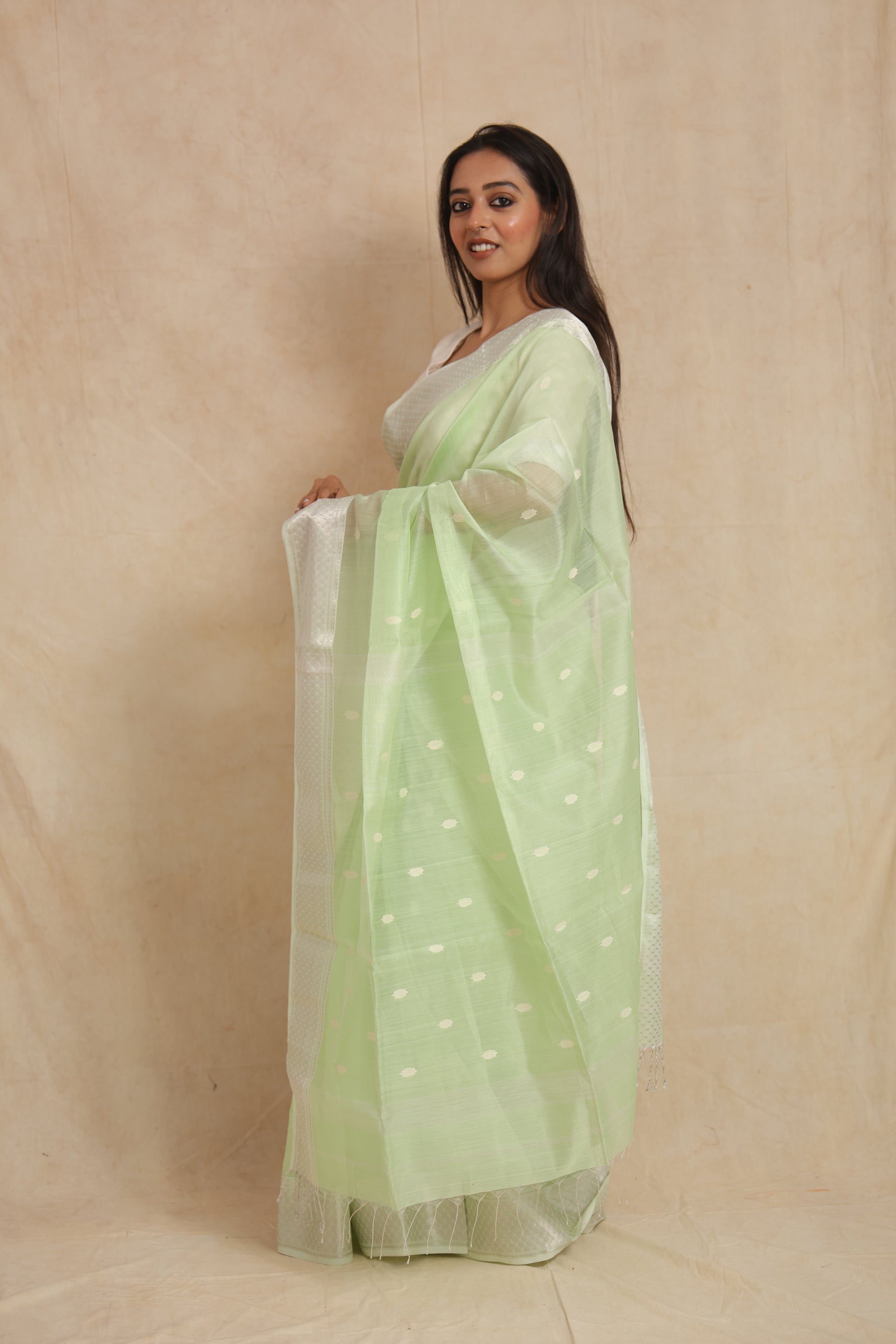 Side profile of handwoven pastel mint green Maheshwari SICO saree with graceful drape