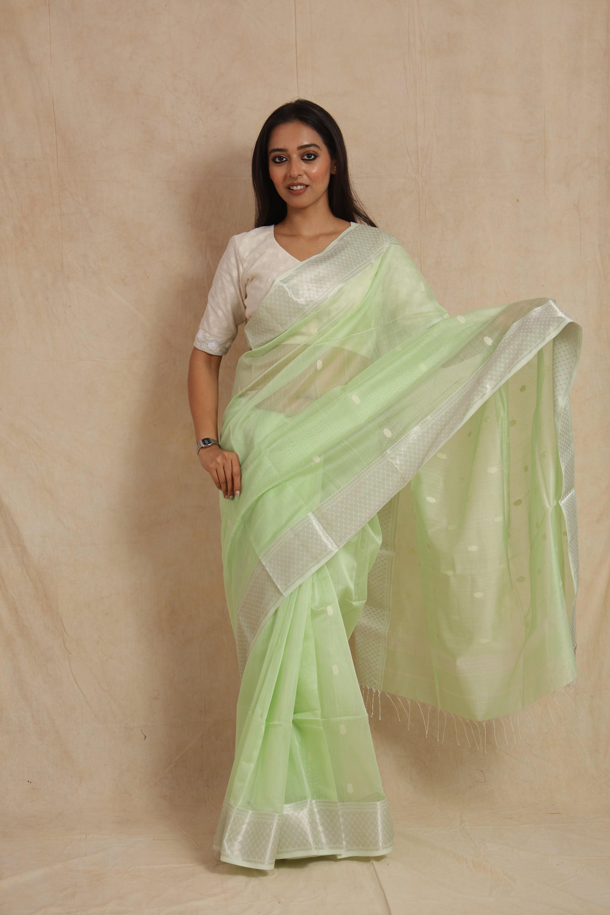 Detailed view of pastel mint green Maheshwari SICO saree highlighting woven buttas and border