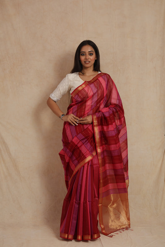Front view of a handwoven Maheshwari cotton saree featuring wine, pink, and purple stripes with a classic gold border.