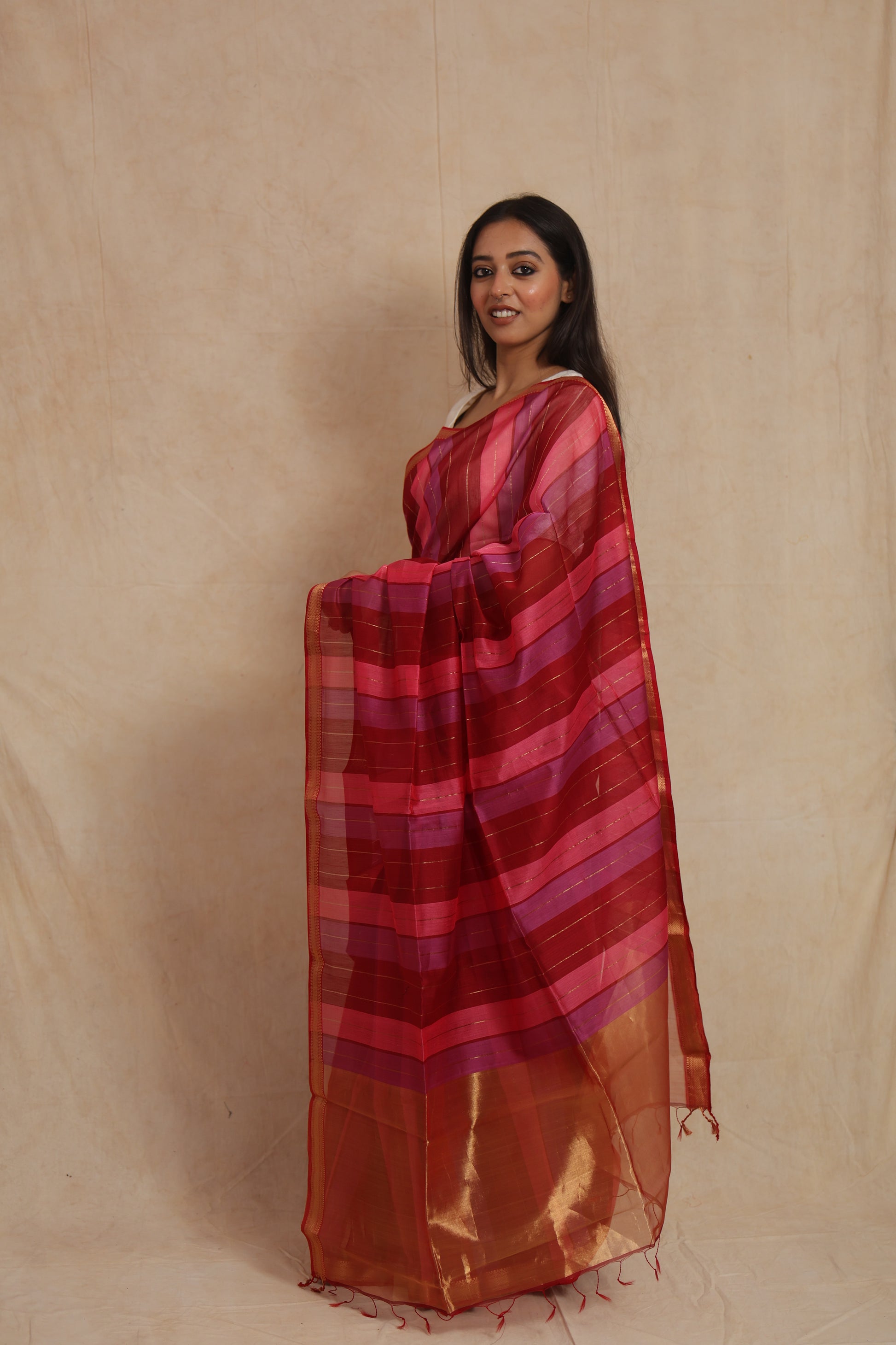 Side profile of the handwoven Maheshwari cotton saree with wine, pink, and purple striped design.