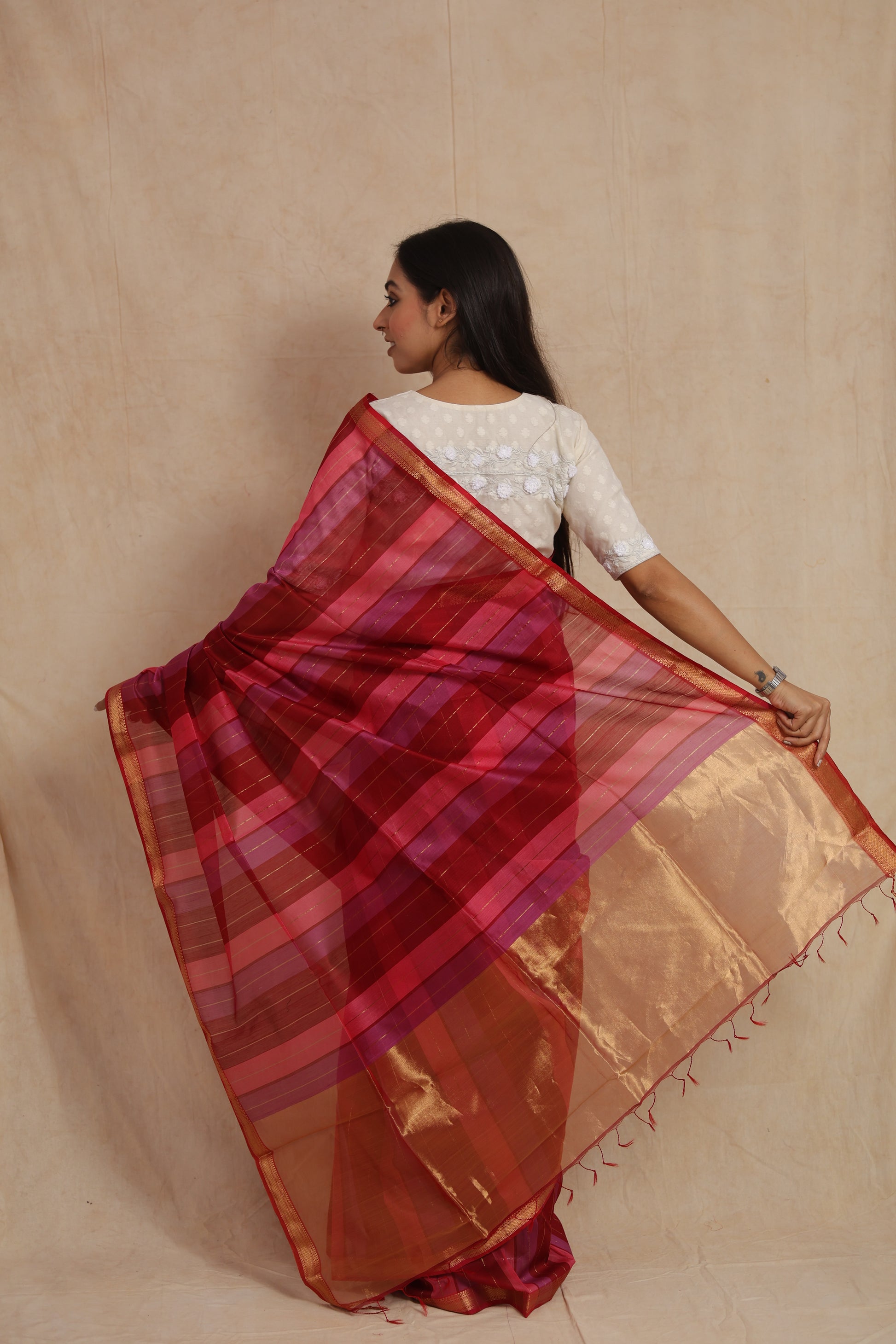 Back view of the Maheshwari cotton saree showcasing its striped pallu and elegant gold border.