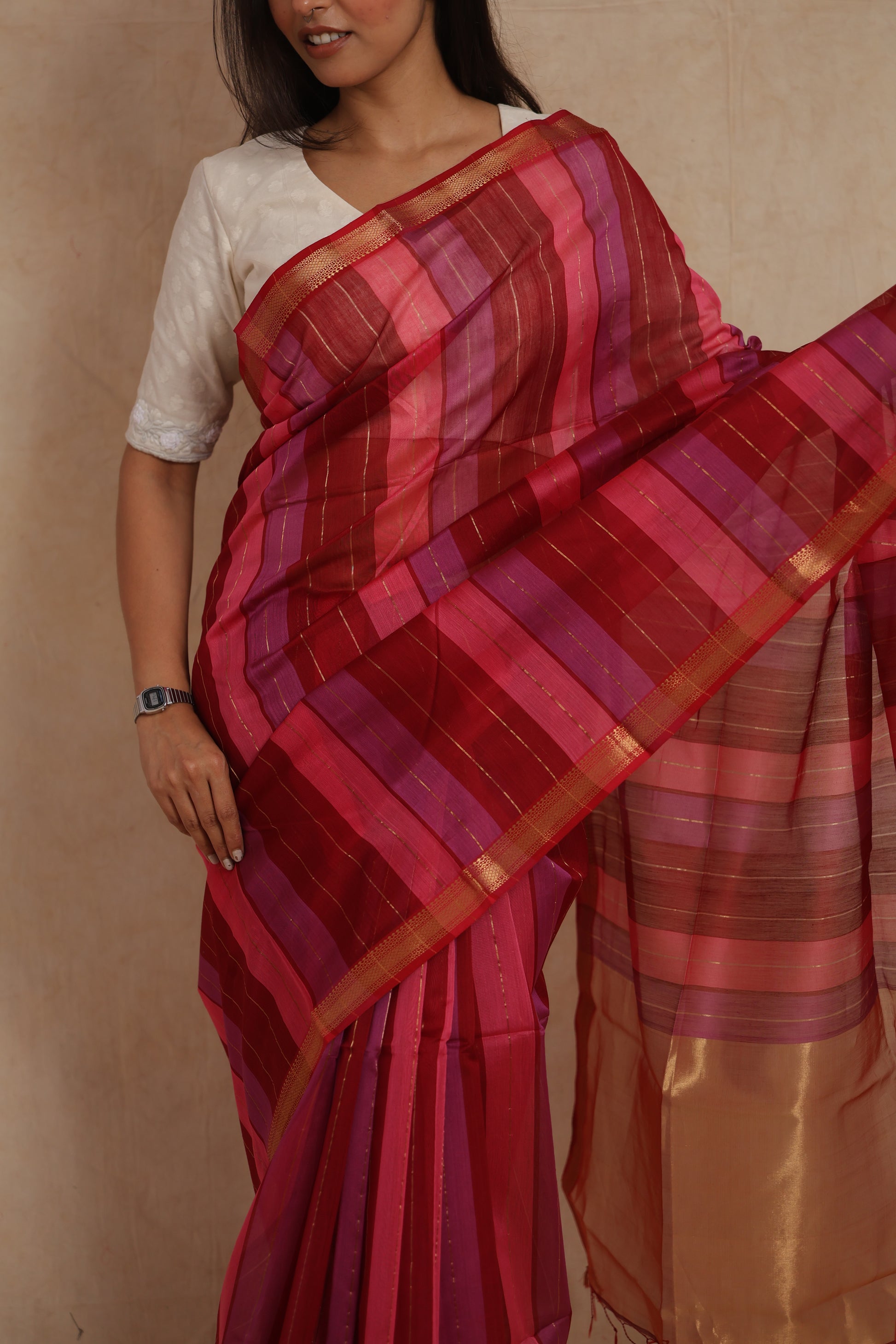 Close-up of the Maheshwari cotton saree highlighting the multicolour striped weave and refined gold border.
