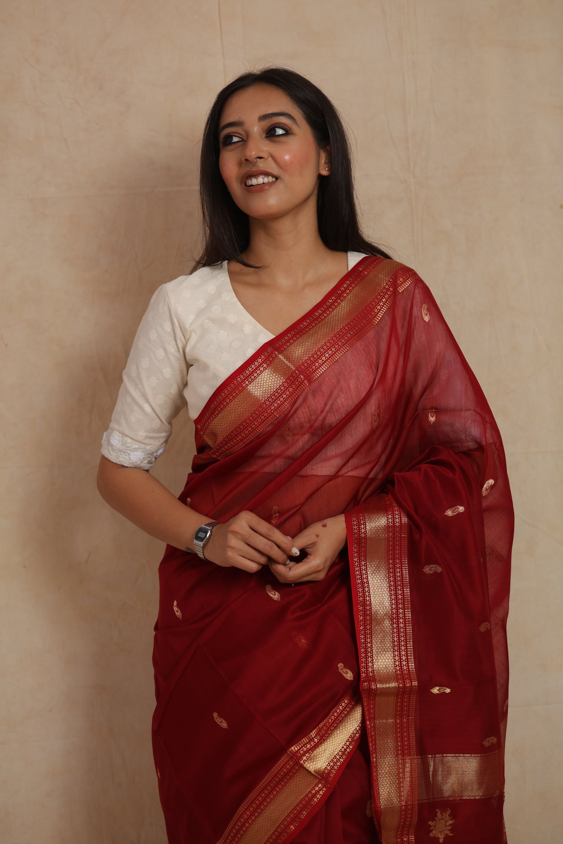 Close-up of ruby red Maheshwari silk cotton saree with woven buttas and rich pallu