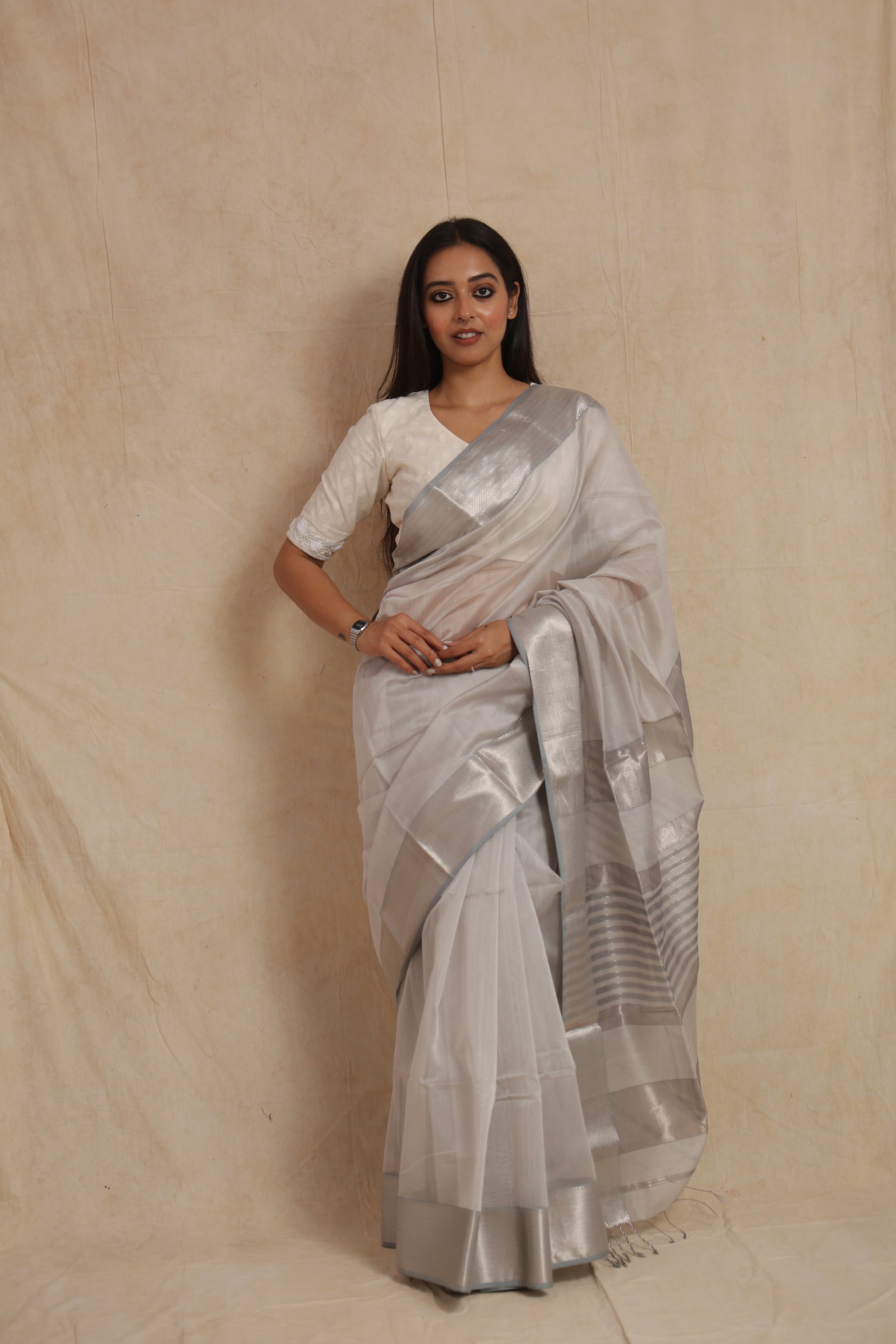 Full drape look of pearl white Maheshwari silk cotton saree with elegant silver pallu