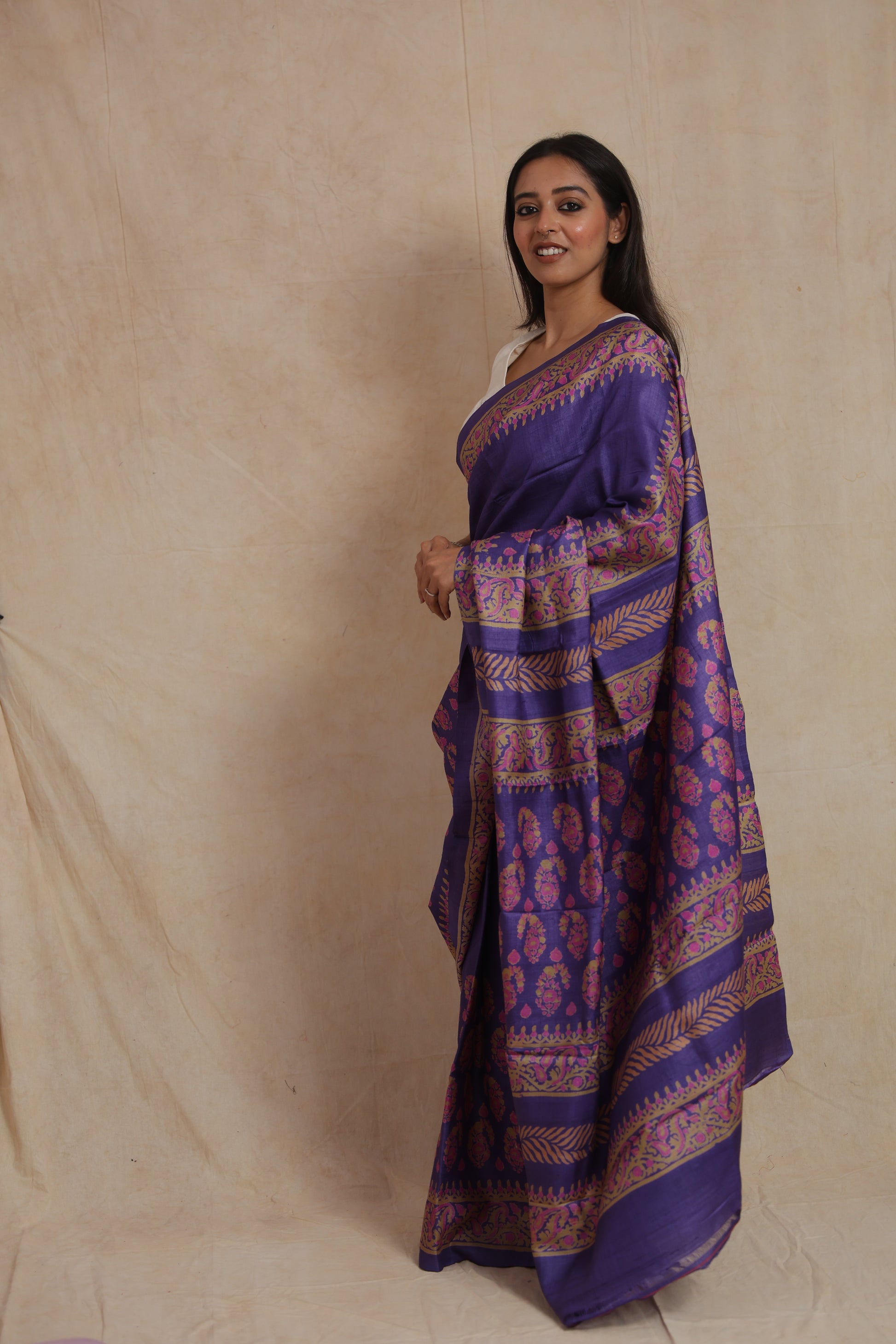 Side profile of royal purple Tassar printed saree with traditional printed pallu