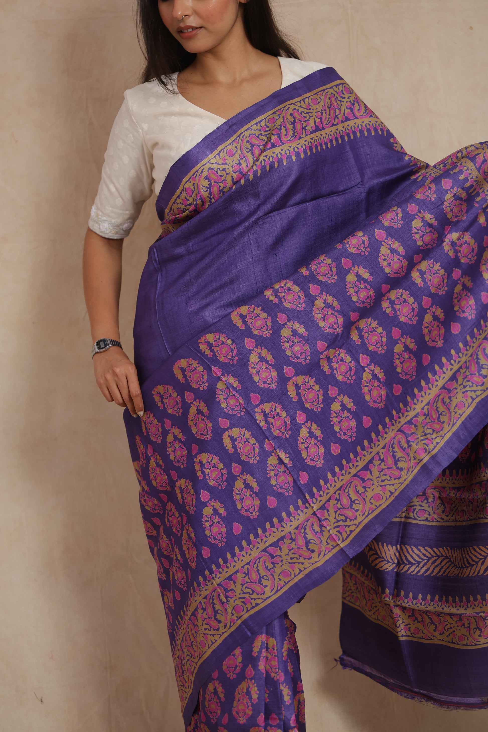 Detailed close-up of paisley printed border on royal purple Tassar saree