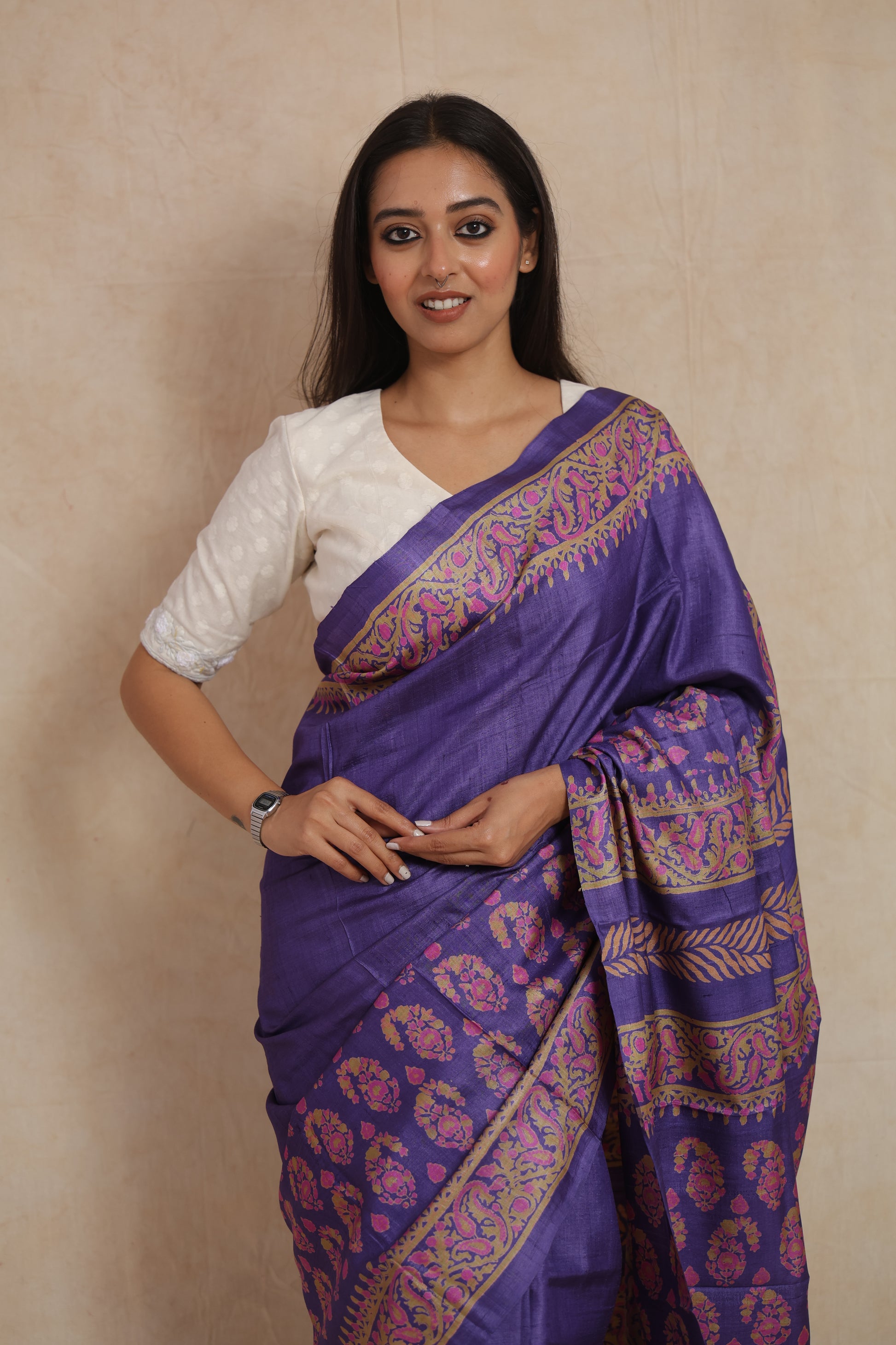 Close-up of floral butta print and decorative border on purple Tassar saree
