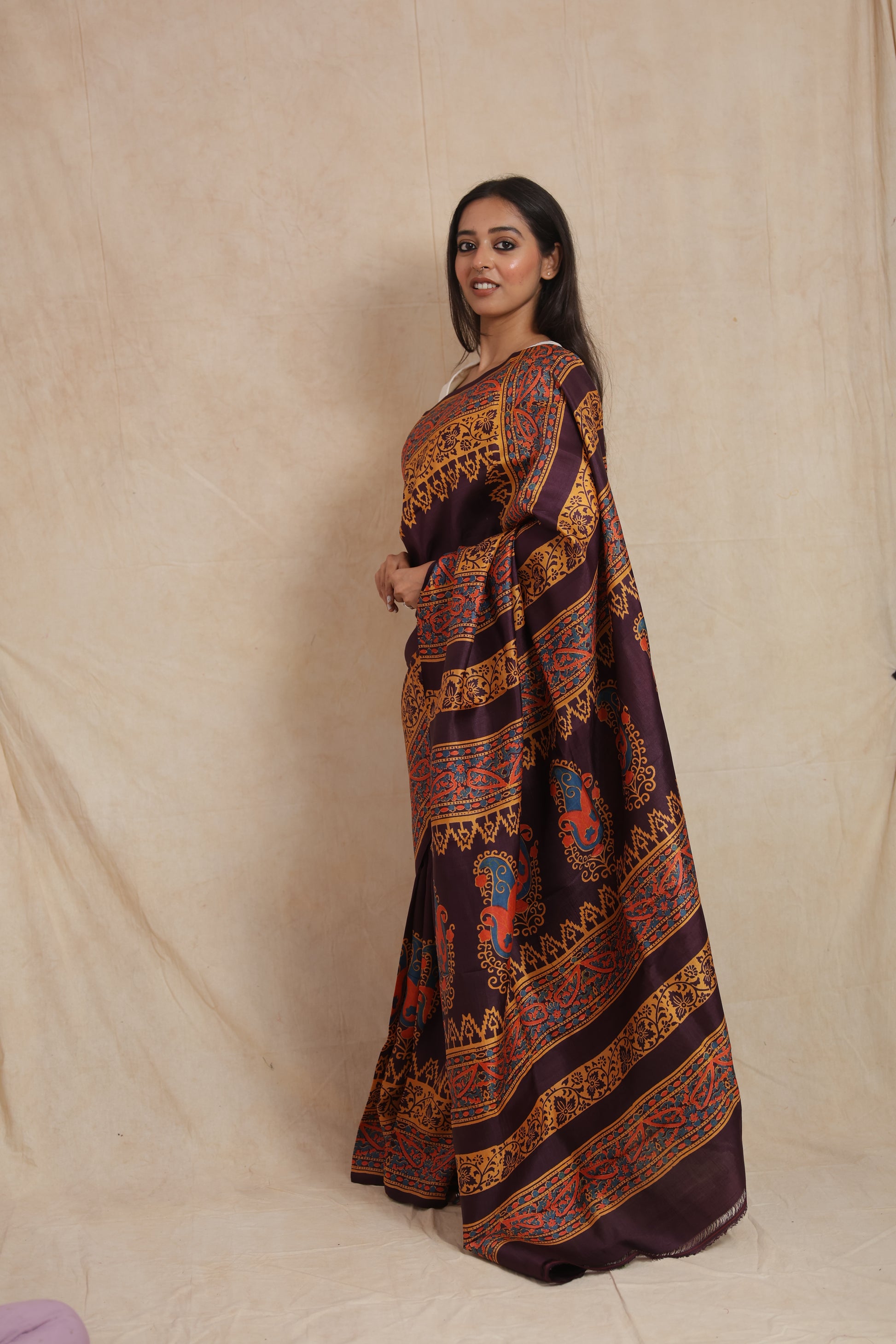 Back view showcasing the richly patterned pallu of the aubergine Batik silk saree