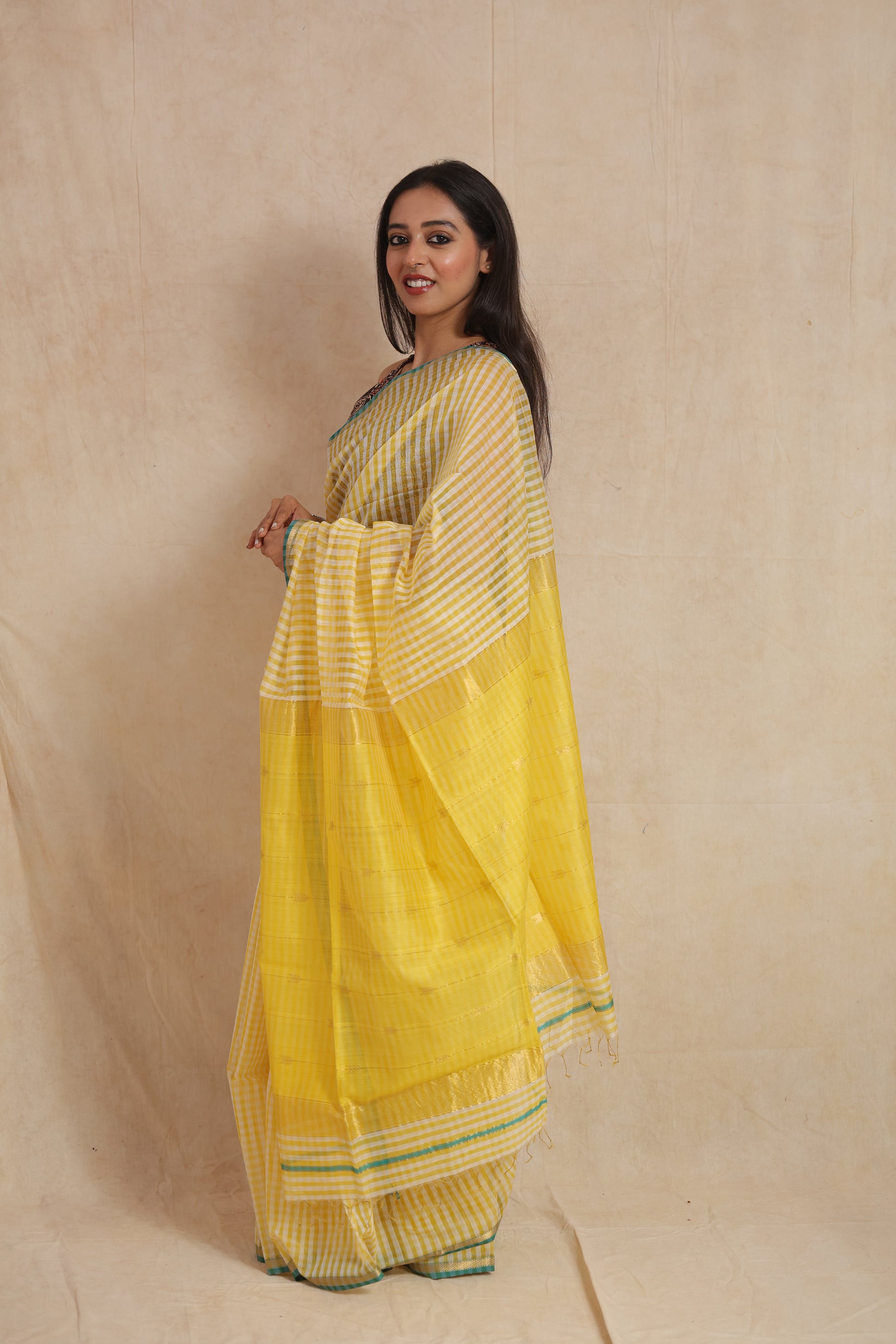 Side view of sunshine yellow Maheshwari handloom silk saree with woven pallu