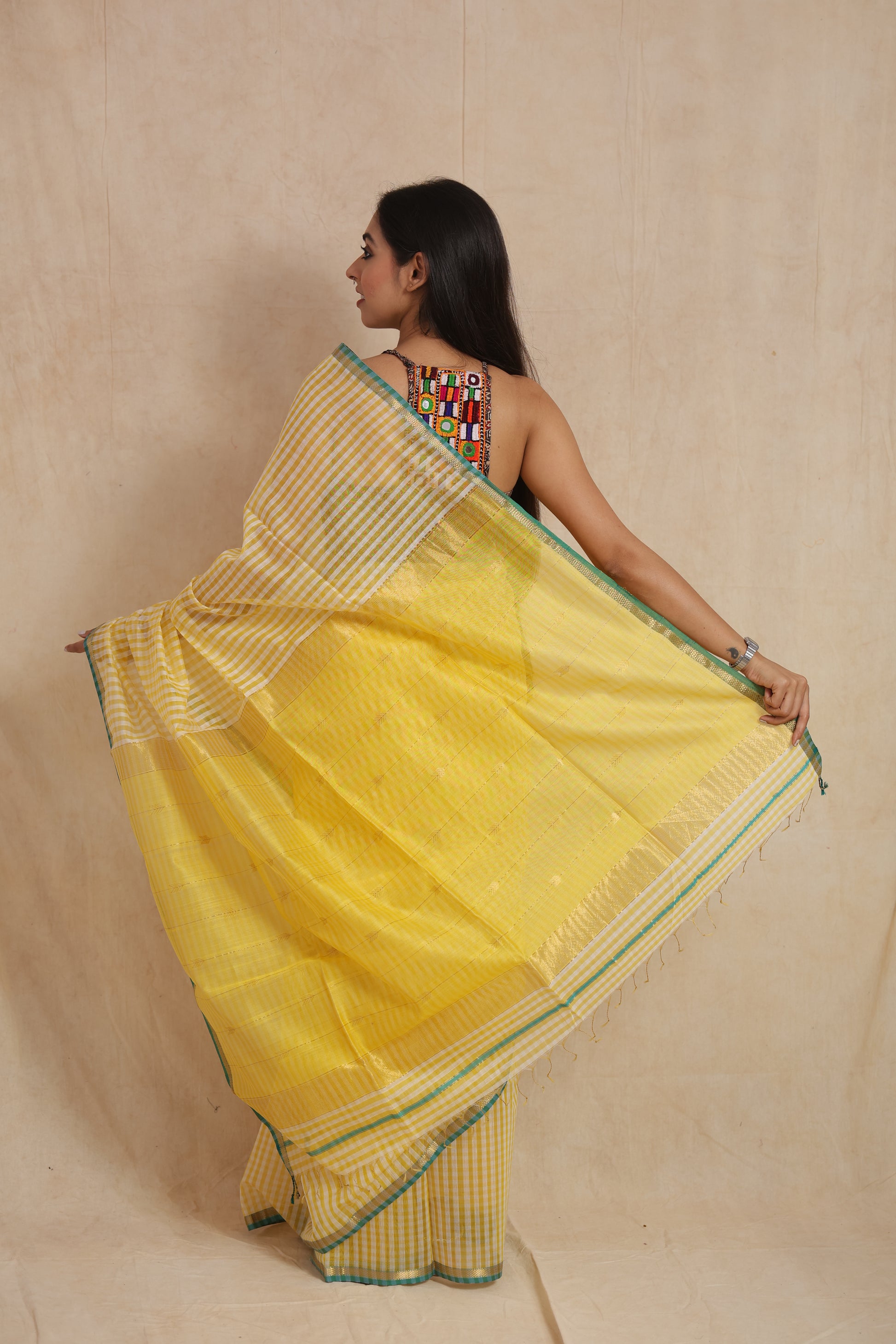 Back view of sunshine yellow Maheshwari handloom silk saree showcasing contrast pallu