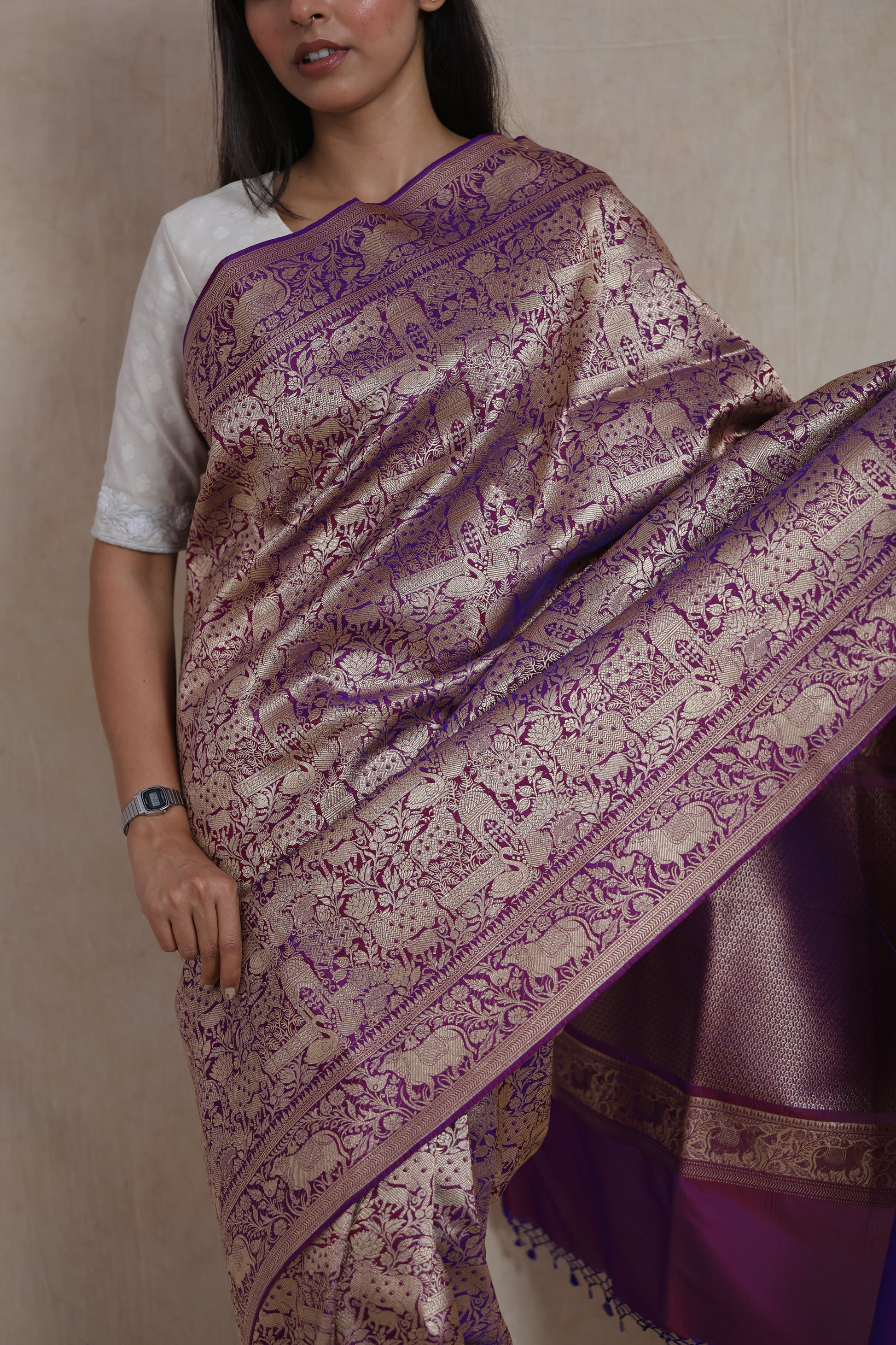 Close-up of the Banarasi silk saree featuring antique gold zari elephant and floral motifs