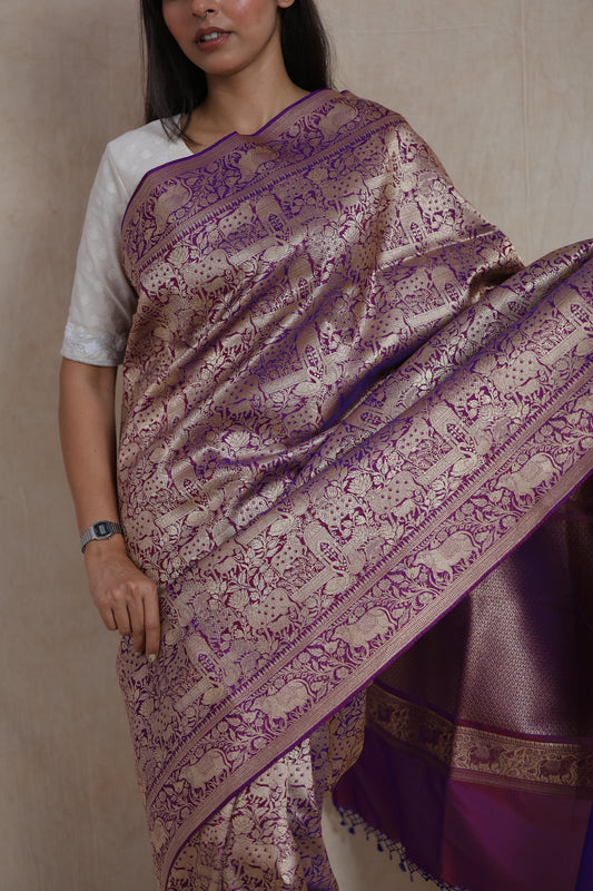 Close-up of the Banarasi silk saree featuring antique gold zari elephant and floral motifs