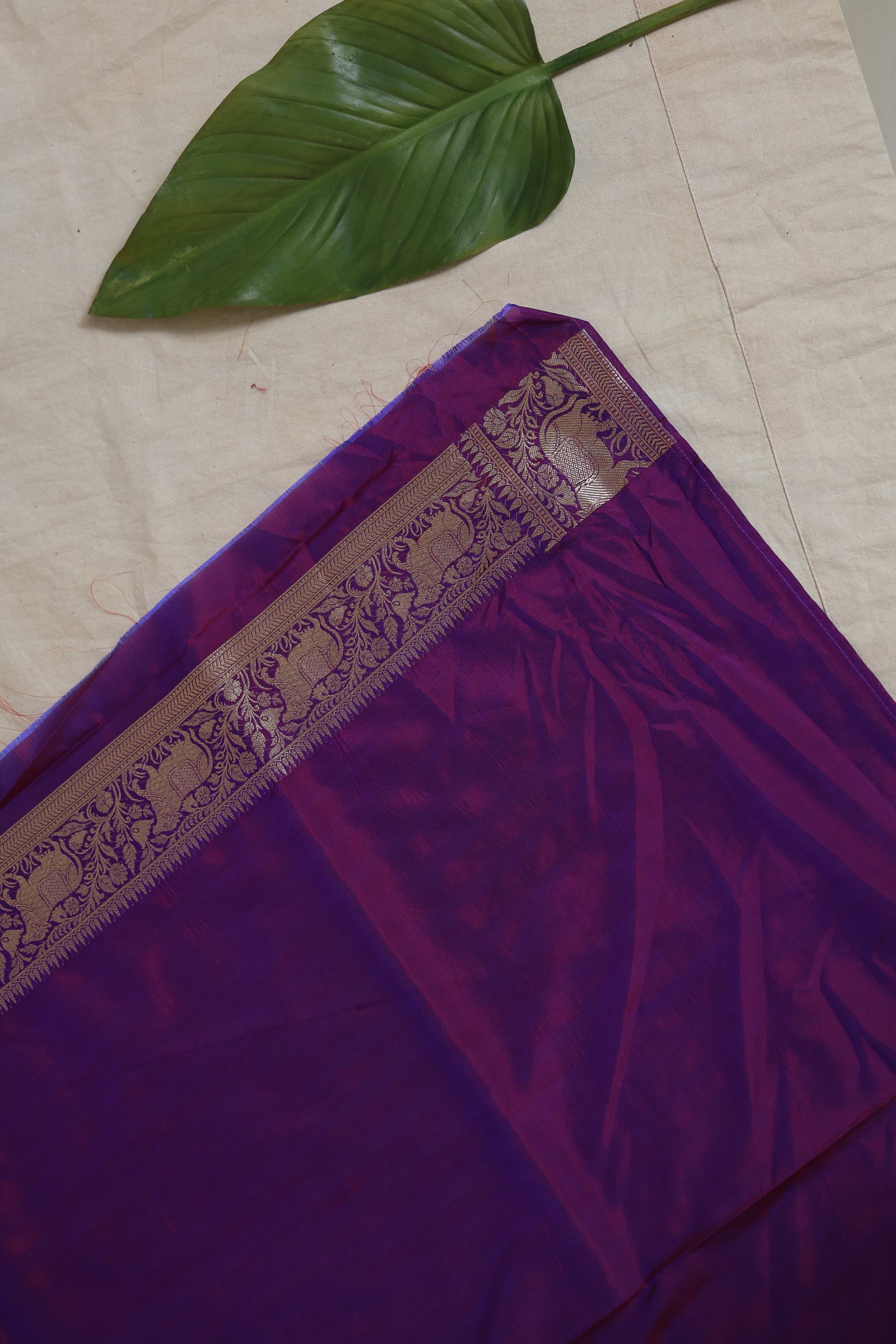 Detailed view of the royal purple Banarasi silk saree pallu and woven border