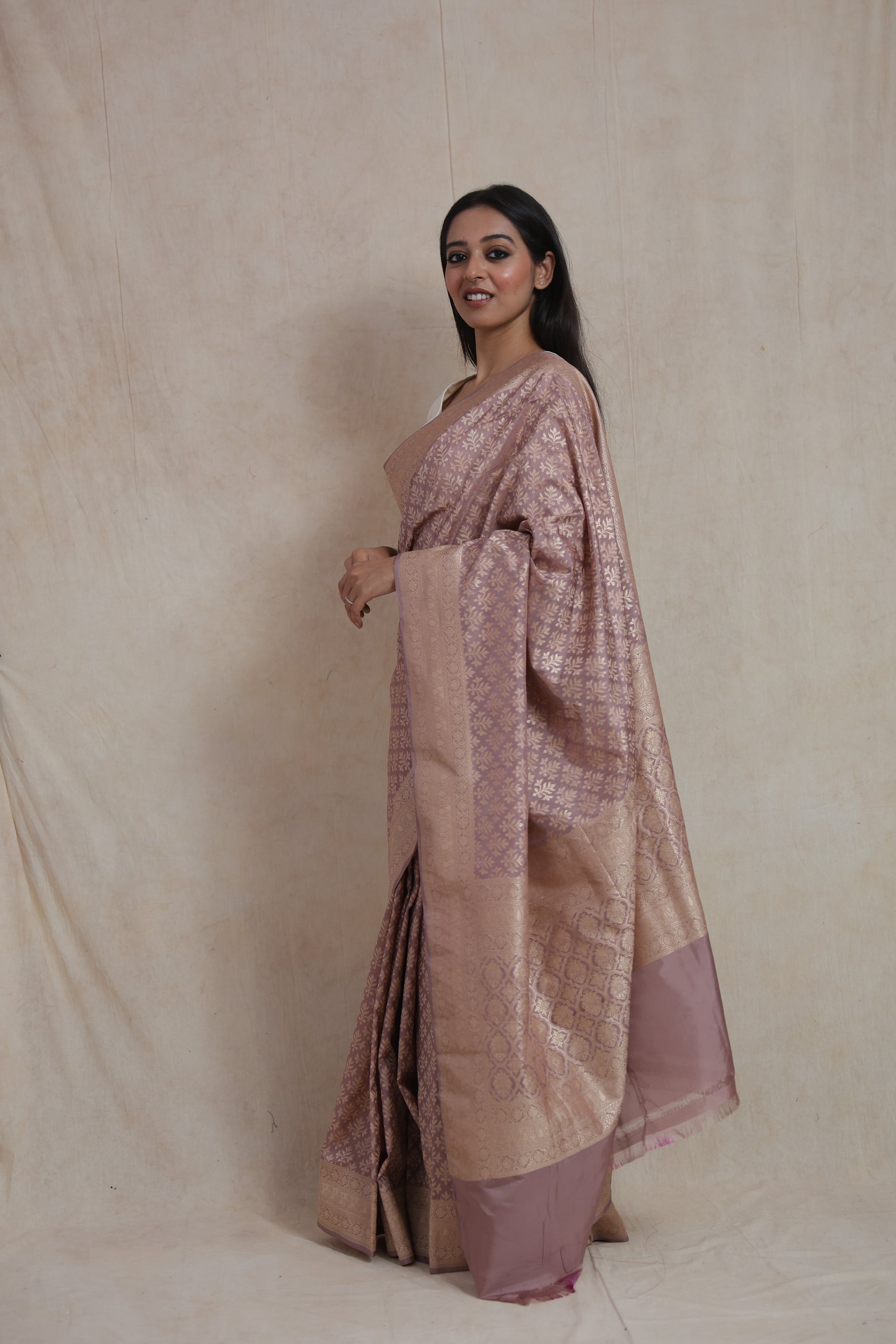 Side profile of dusty rose Banarasi art silk saree with luxurious woven pallu and traditional floral design