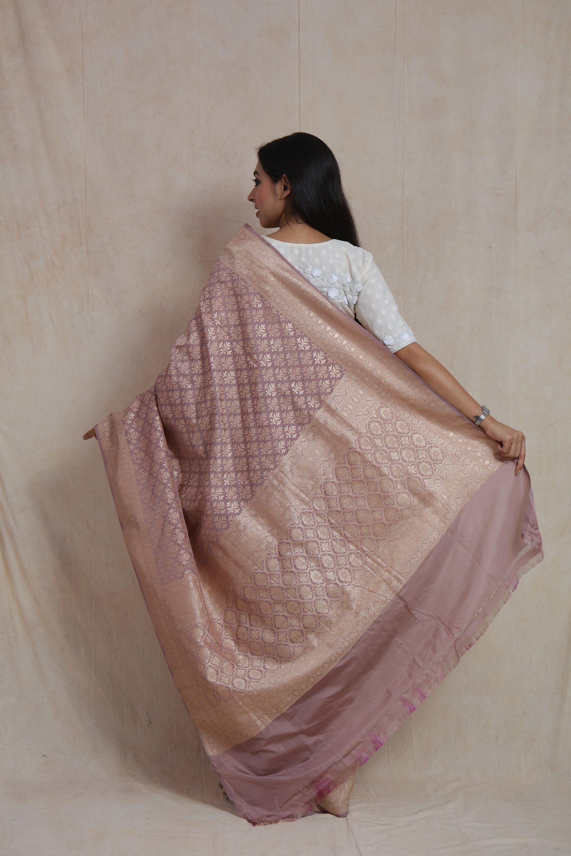 Back view of dusty rose Banarasi art silk saree showcasing intricate floral weaving and richly detailed pallu