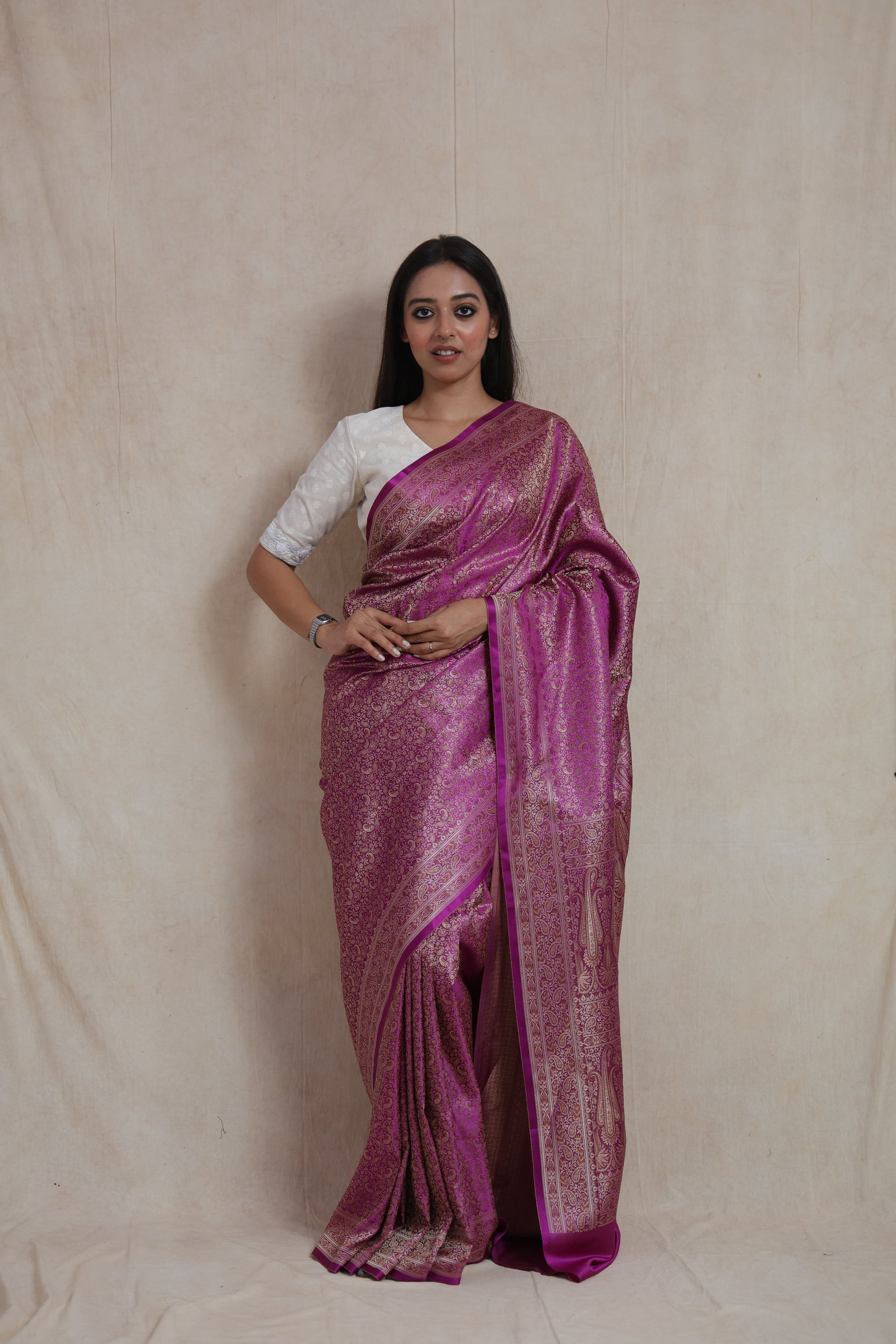 Model wearing radiant magenta Banarasi silk saree with antique gold woven floral motifs