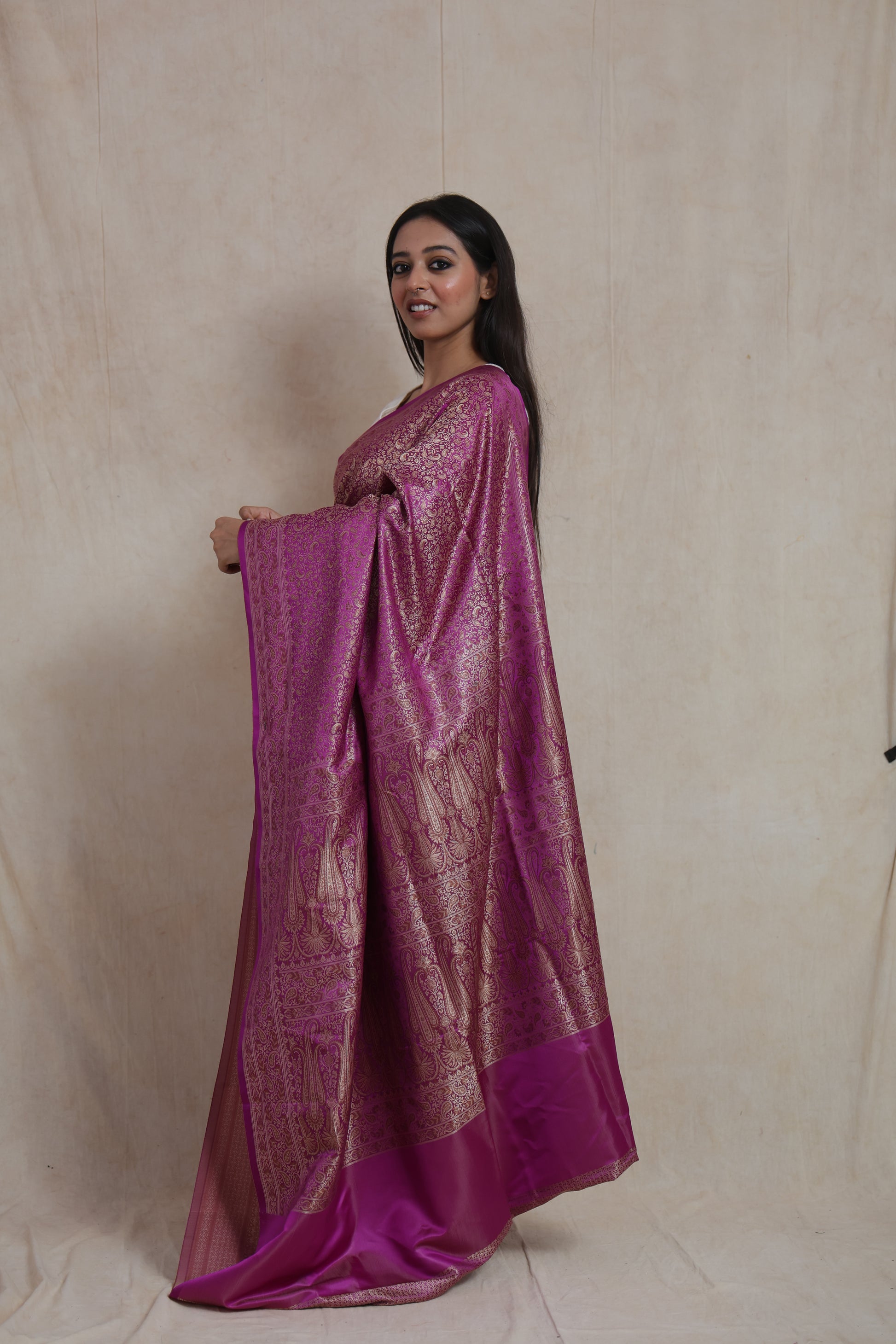 Side profile of radiant magenta Banarasi silk saree with elegant woven border