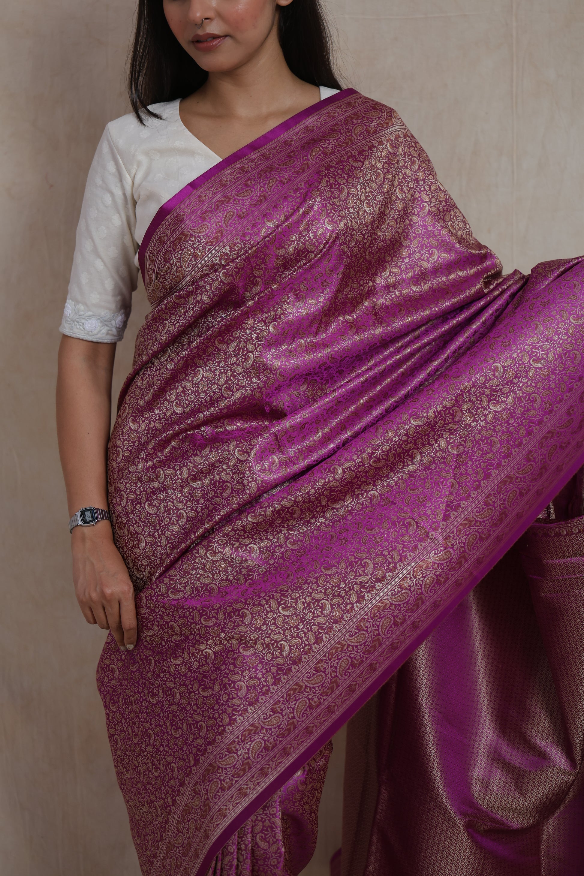 Detailed view of the magenta Banarasi silk saree highlighting floral woven motifs and border