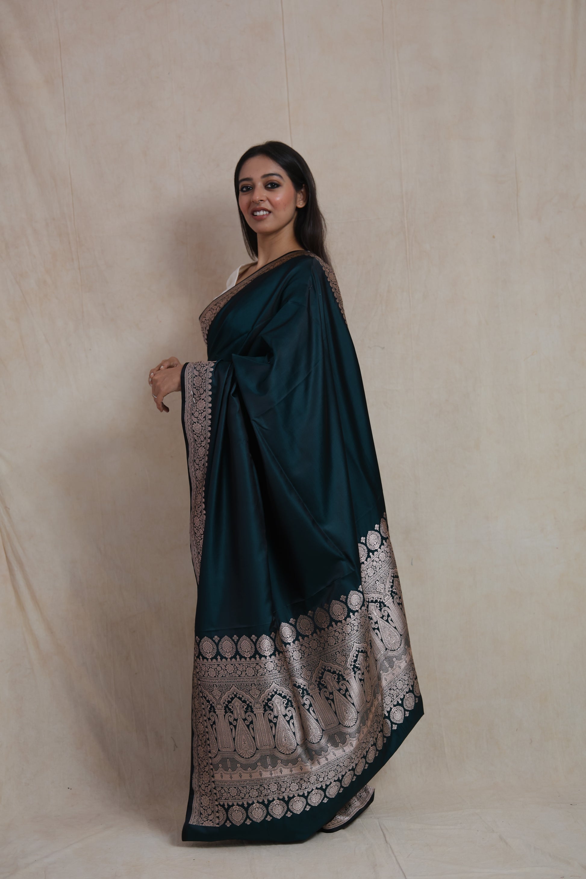 Side profile of midnight teal Banarasi art silk saree highlighting the grand woven pallu and border
