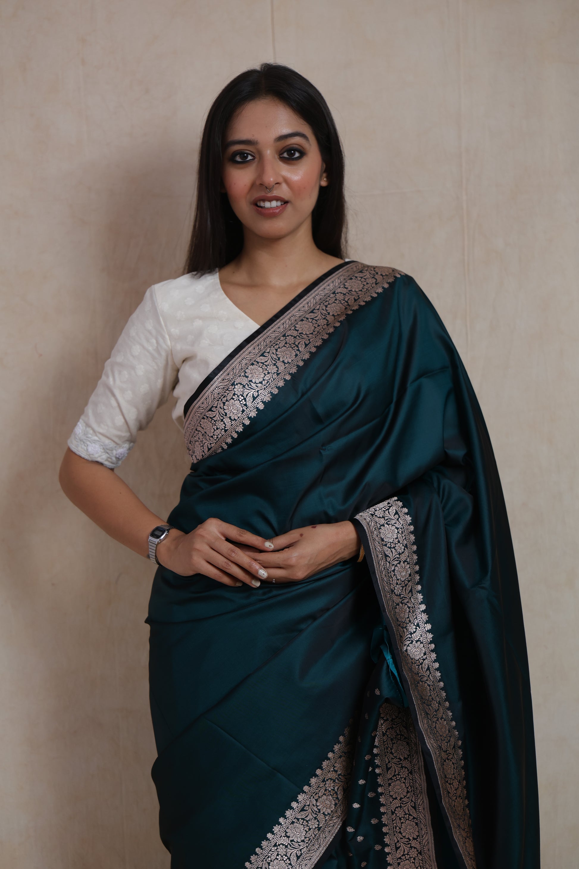Close-up of midnight teal Banarasi art silk saree showcasing intricate woven border and luxurious texture