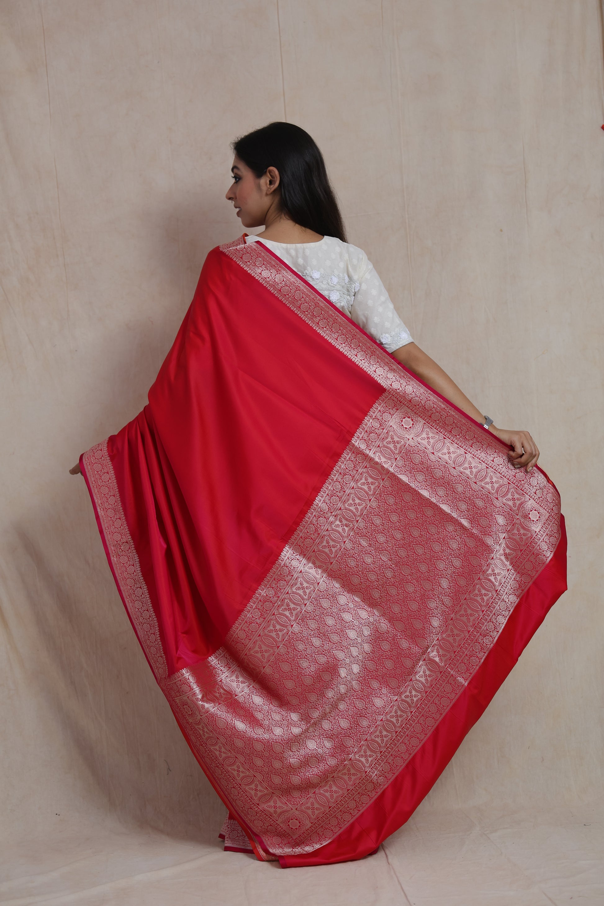 Back view showcasing the rich silver zari woven pallu of the Banarasi silk saree