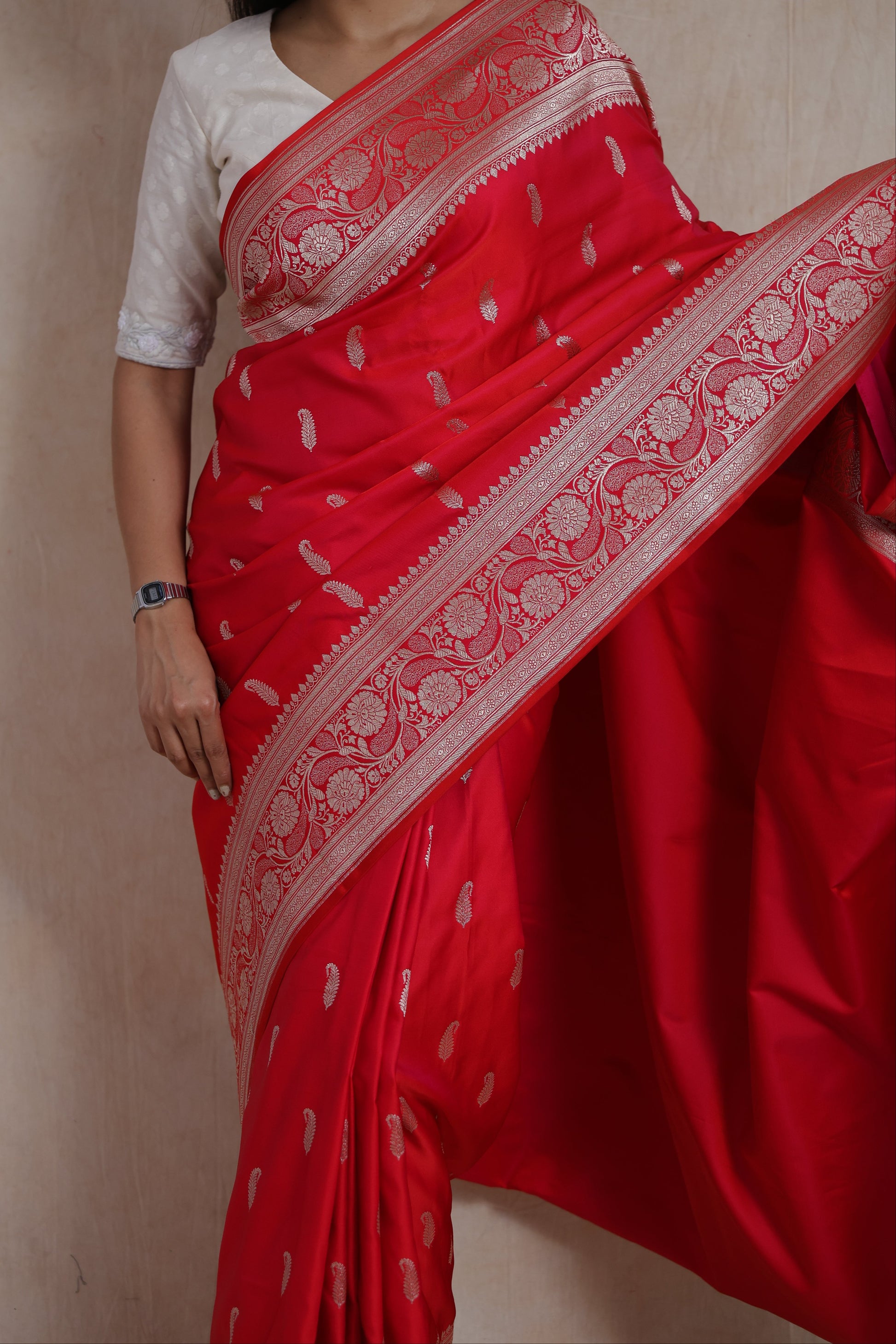 Detailed view of floral woven border and butta motifs on crimson Banarasi art silk saree