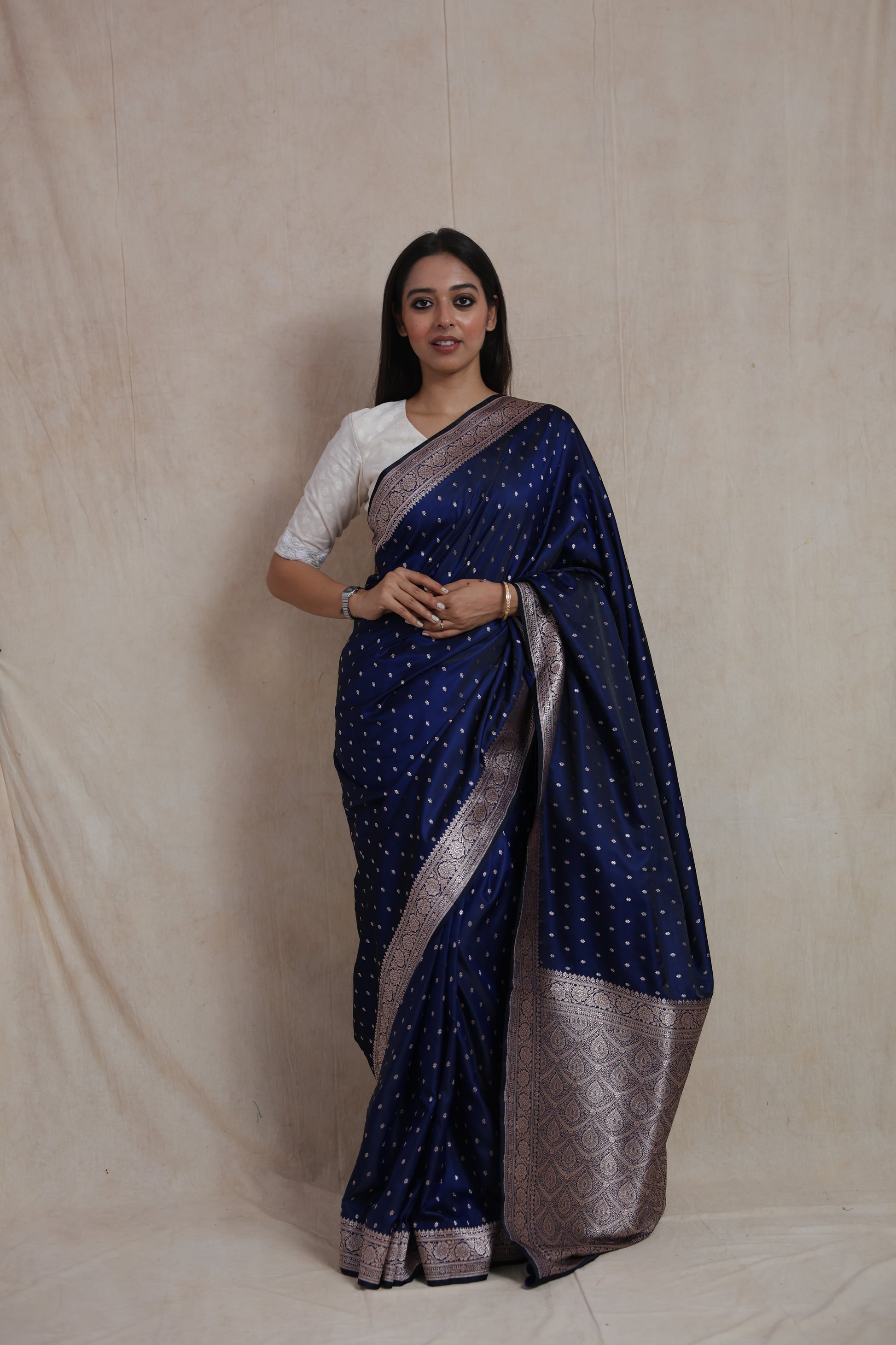 Front view of royal navy blue Banarasi silk saree with silver buttas and woven border