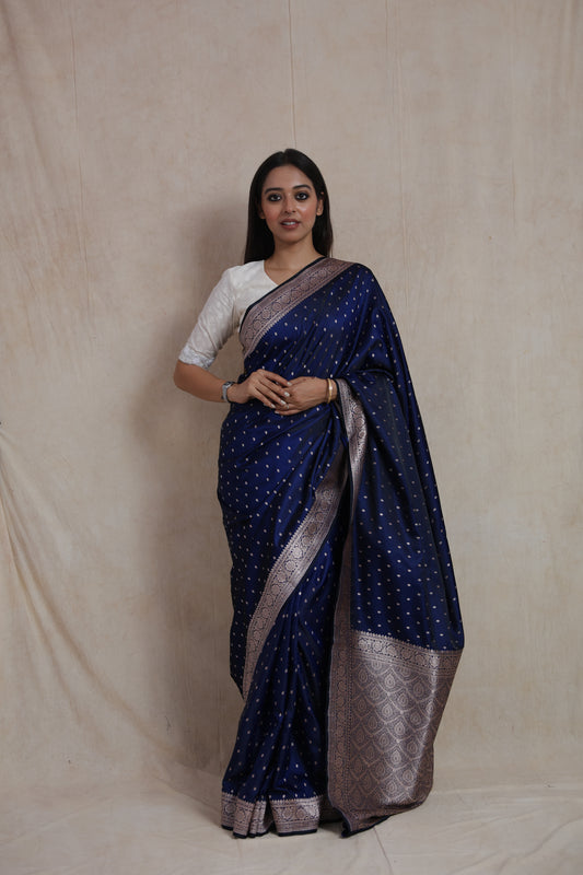 Front view of royal navy blue Banarasi silk saree with silver buttas and woven border