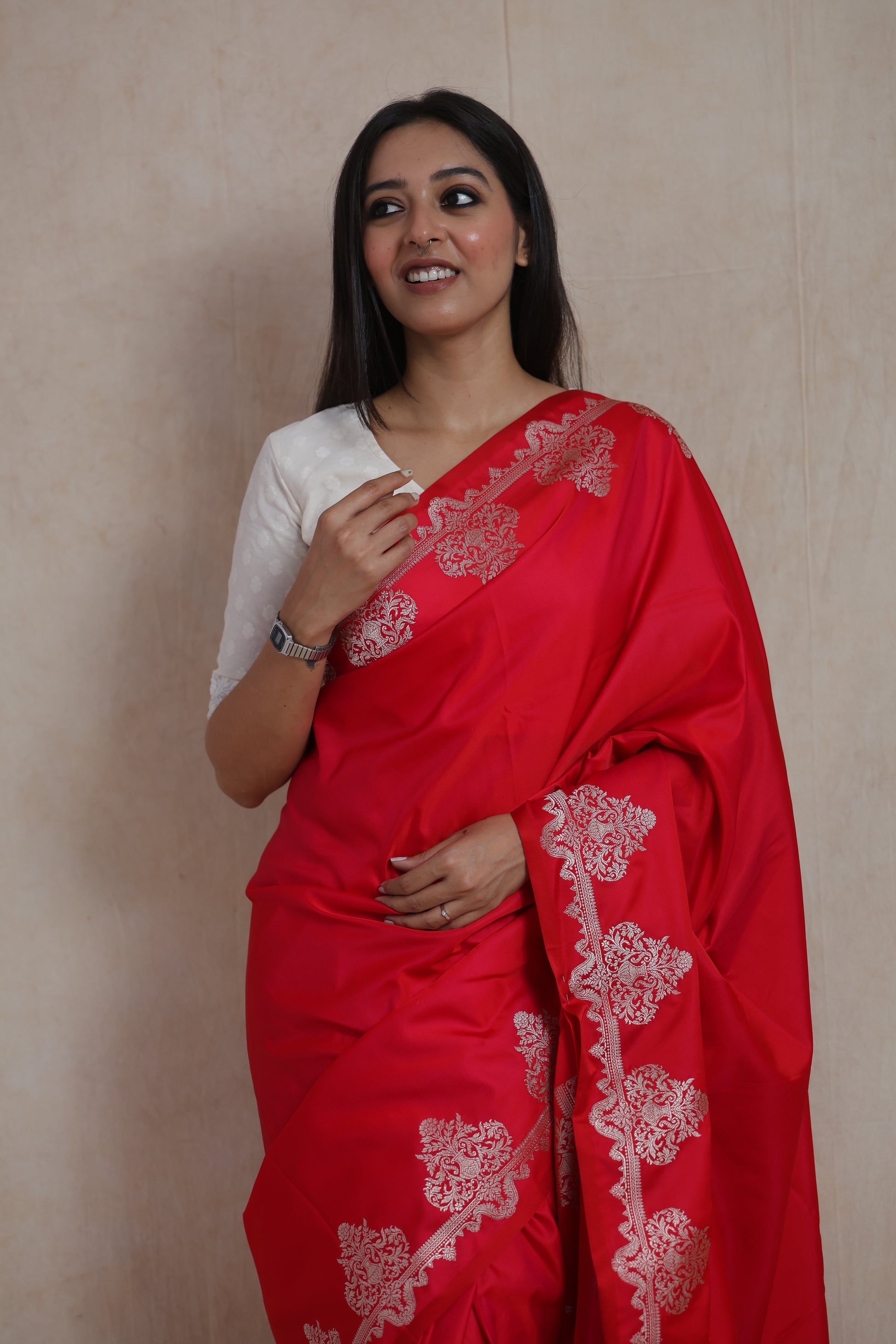 Model wearing a crimson red Banarasi art silk saree with elegant woven border