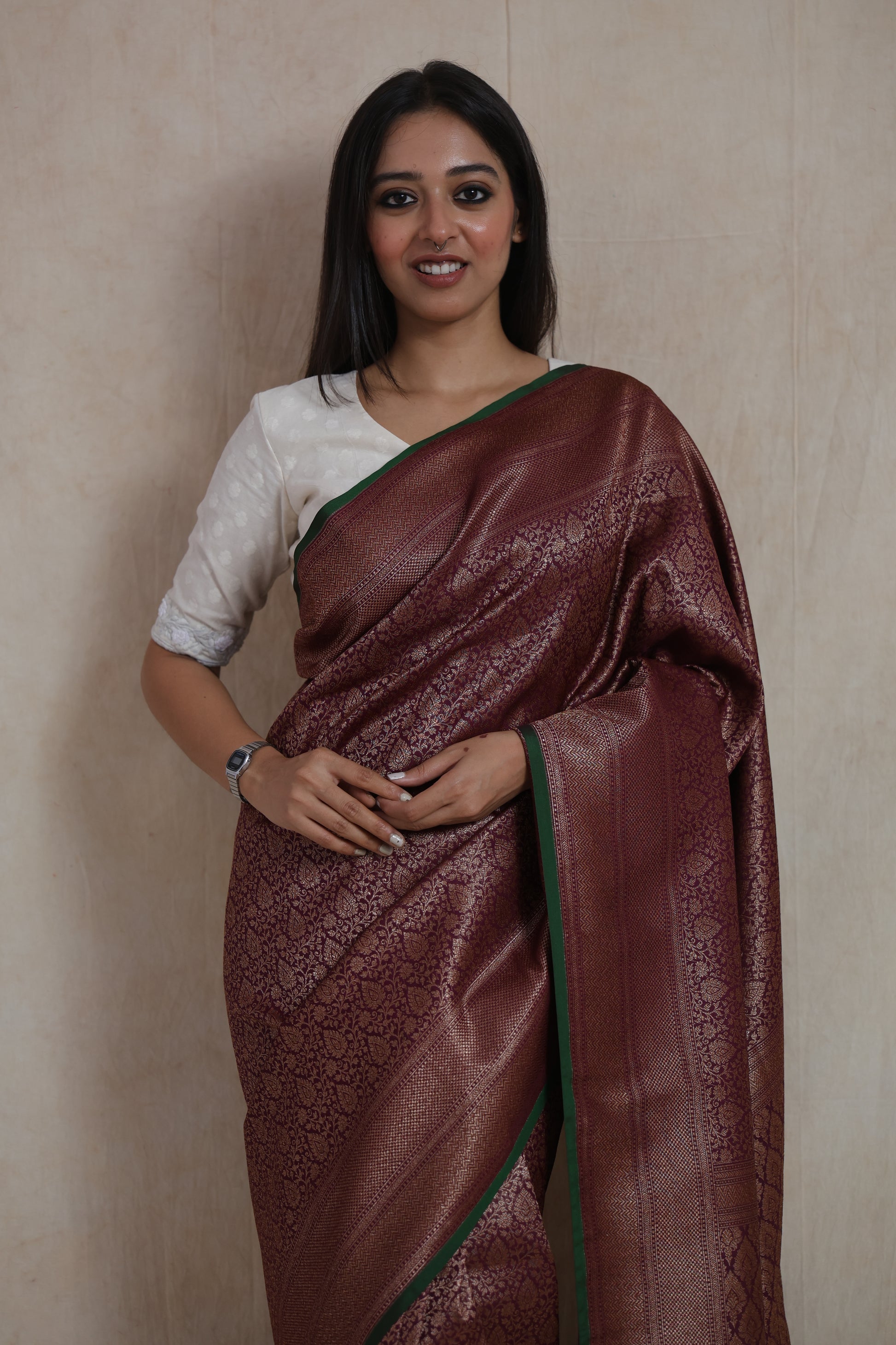 Detailed view of the wine purple Banarasi silk saree with floral woven body and elegant border