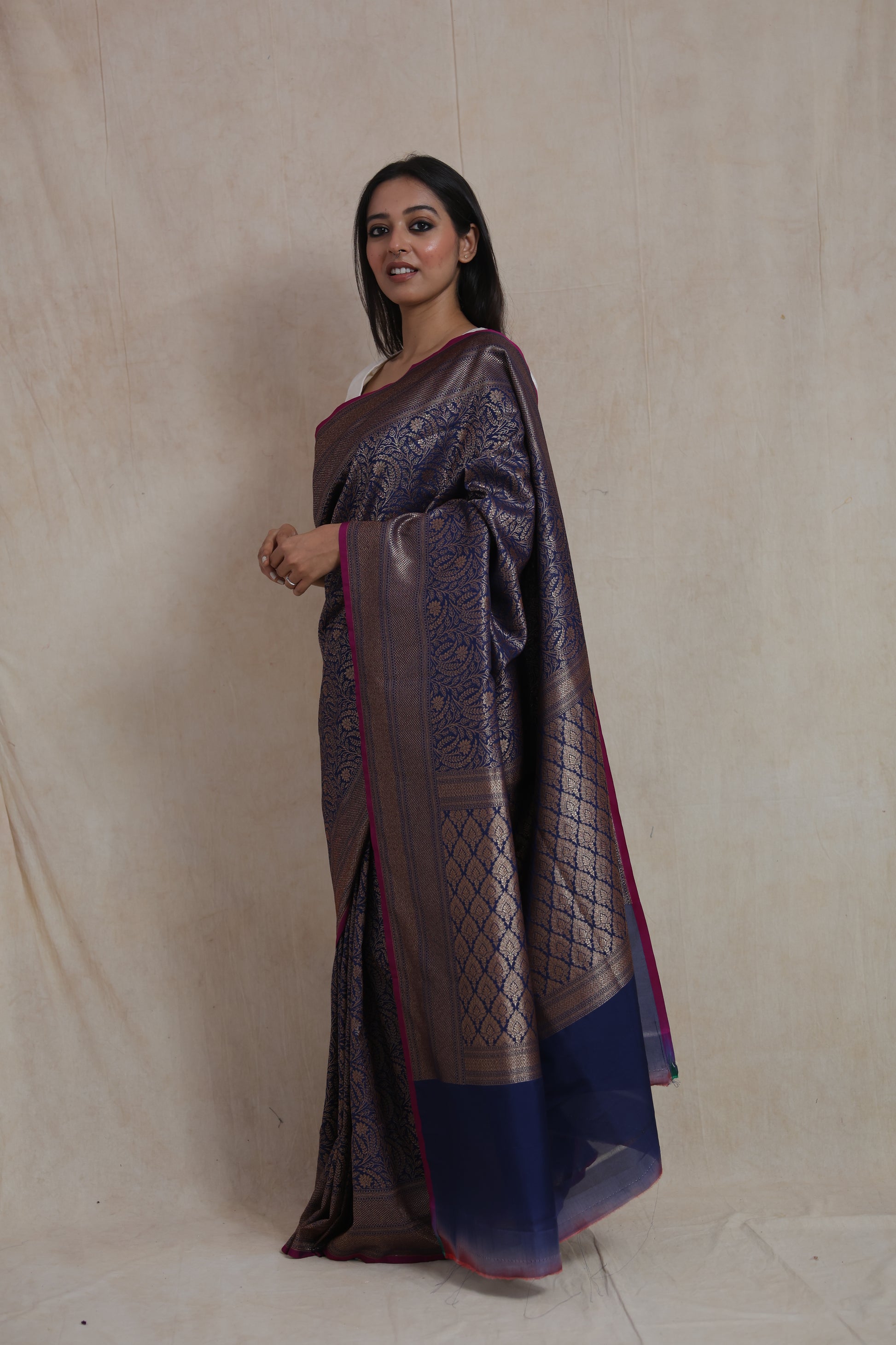 Side view of navy blue Banarasi silk saree with rich woven border