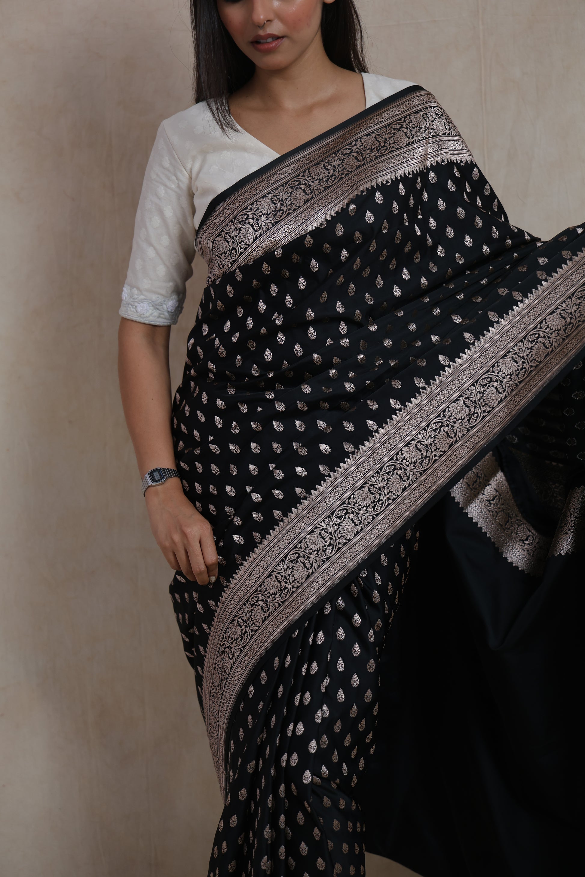 Portrait view of black Banarasi art silk saree with elegant silver woven motifs and traditional pallu
