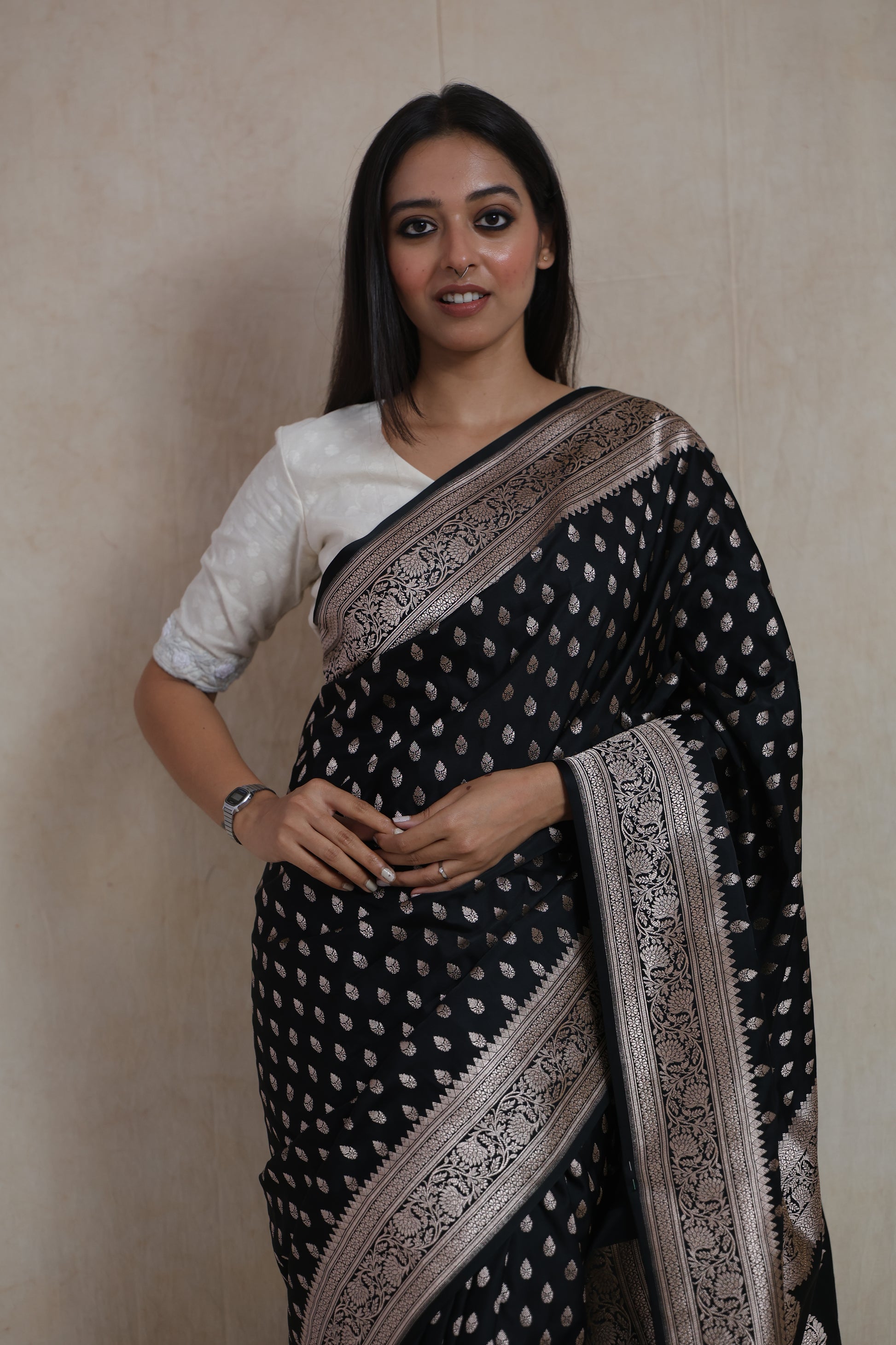 Close-up of black Banarasi art silk saree with silver buttas and detailed floral woven border