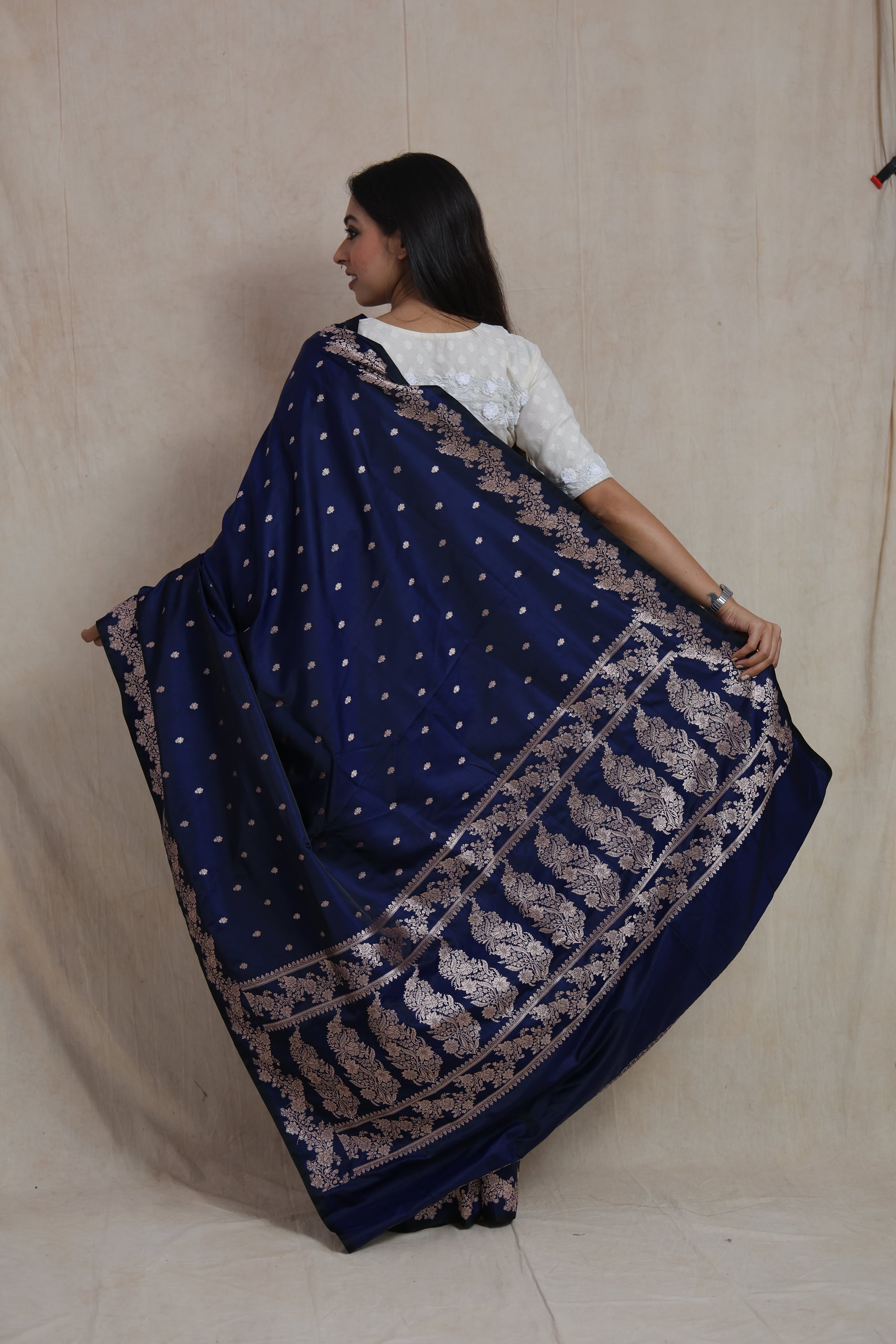 Back view of royal navy blue Banarasi art silk saree showcasing ornate woven pallu design