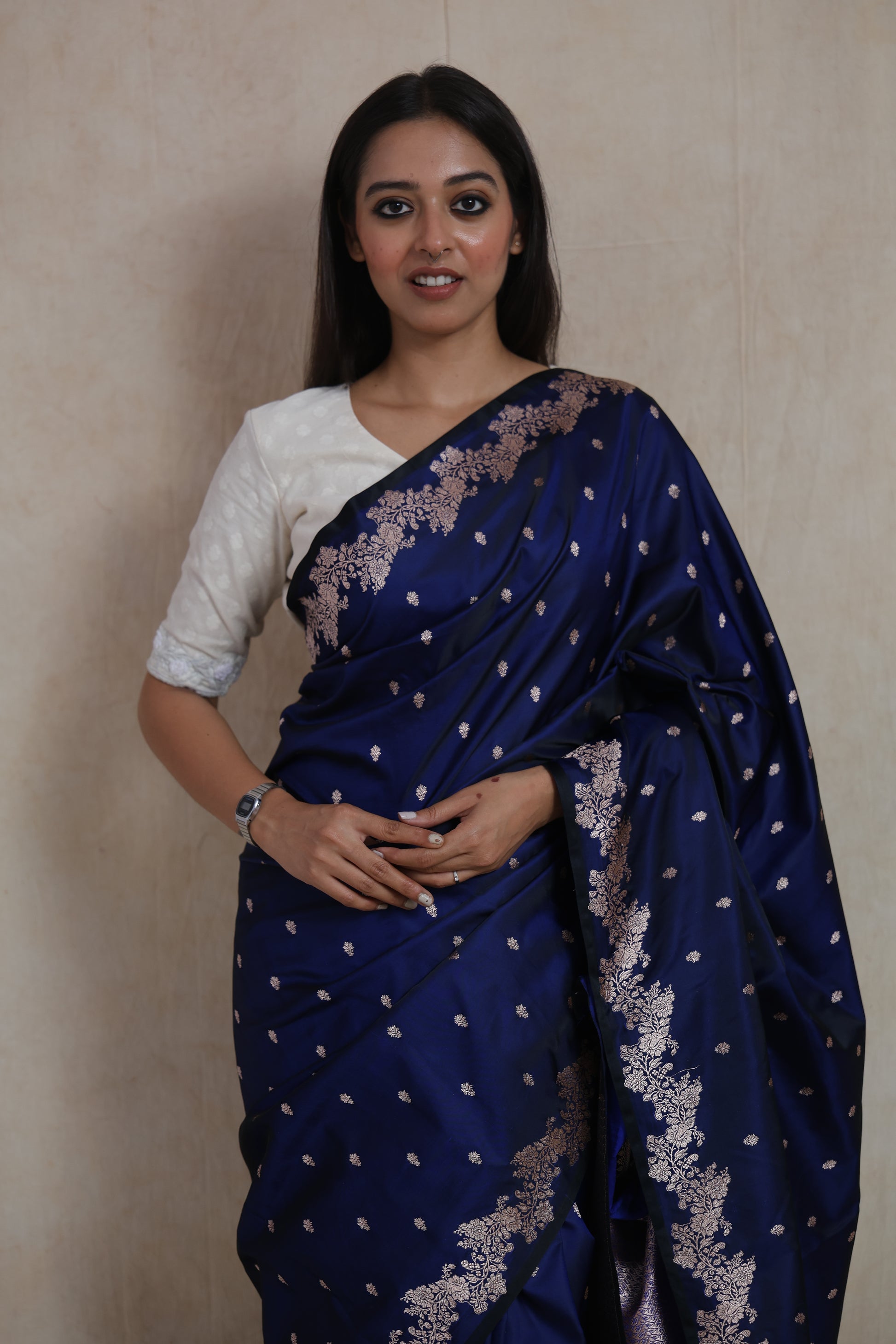 Close-up of royal navy blue Banarasi art silk saree with delicate woven buttas and floral border