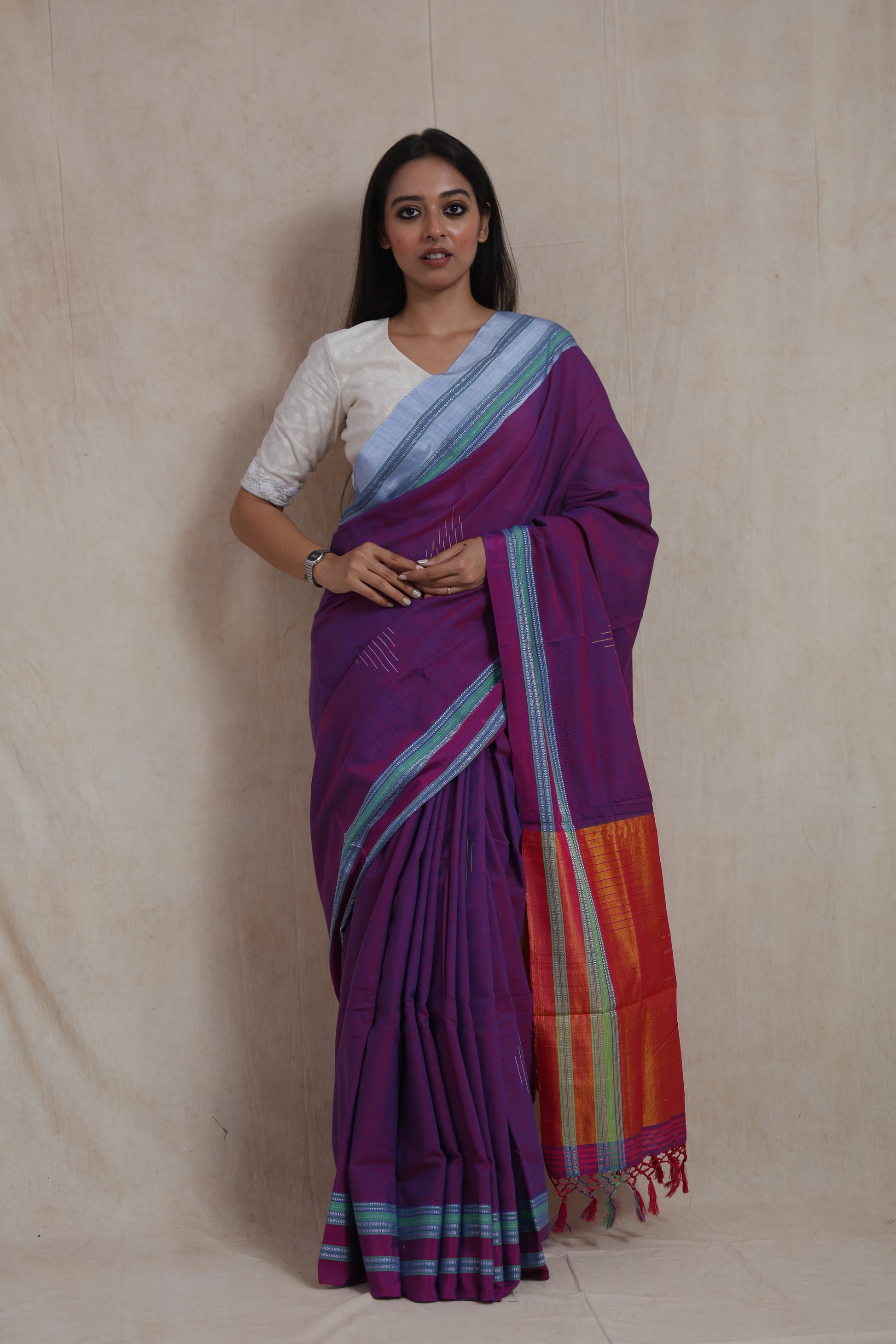 Model wearing royal purple Ilkal handloom cotton saree with contrast orange pallu