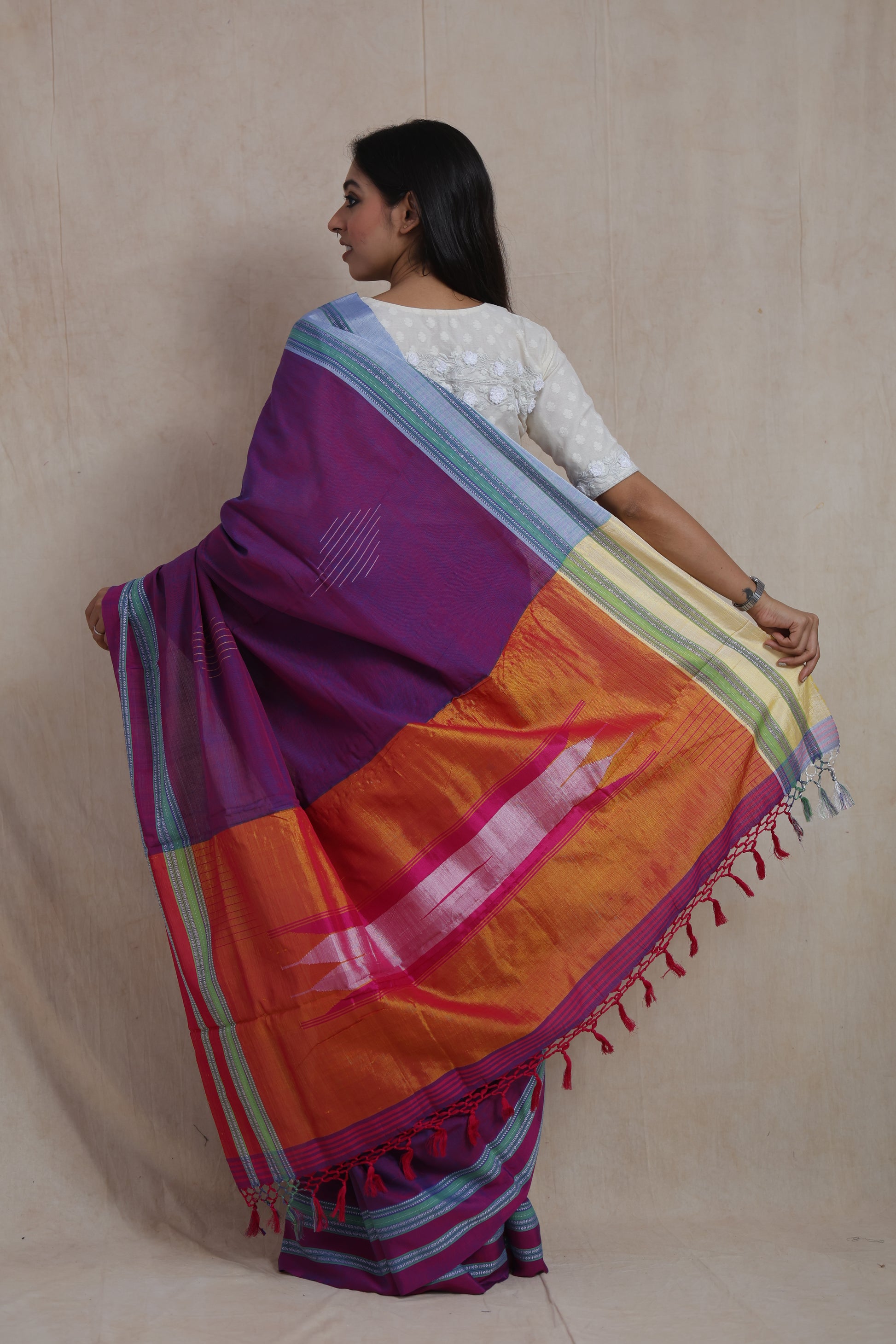 Back view showcasing the orange contrast pallu of a purple Ilkal handloom cotton saree