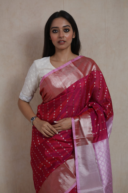 Detailed view of luxurious Kanjivaram silk saree with silver woven pallu and elegant pink border
