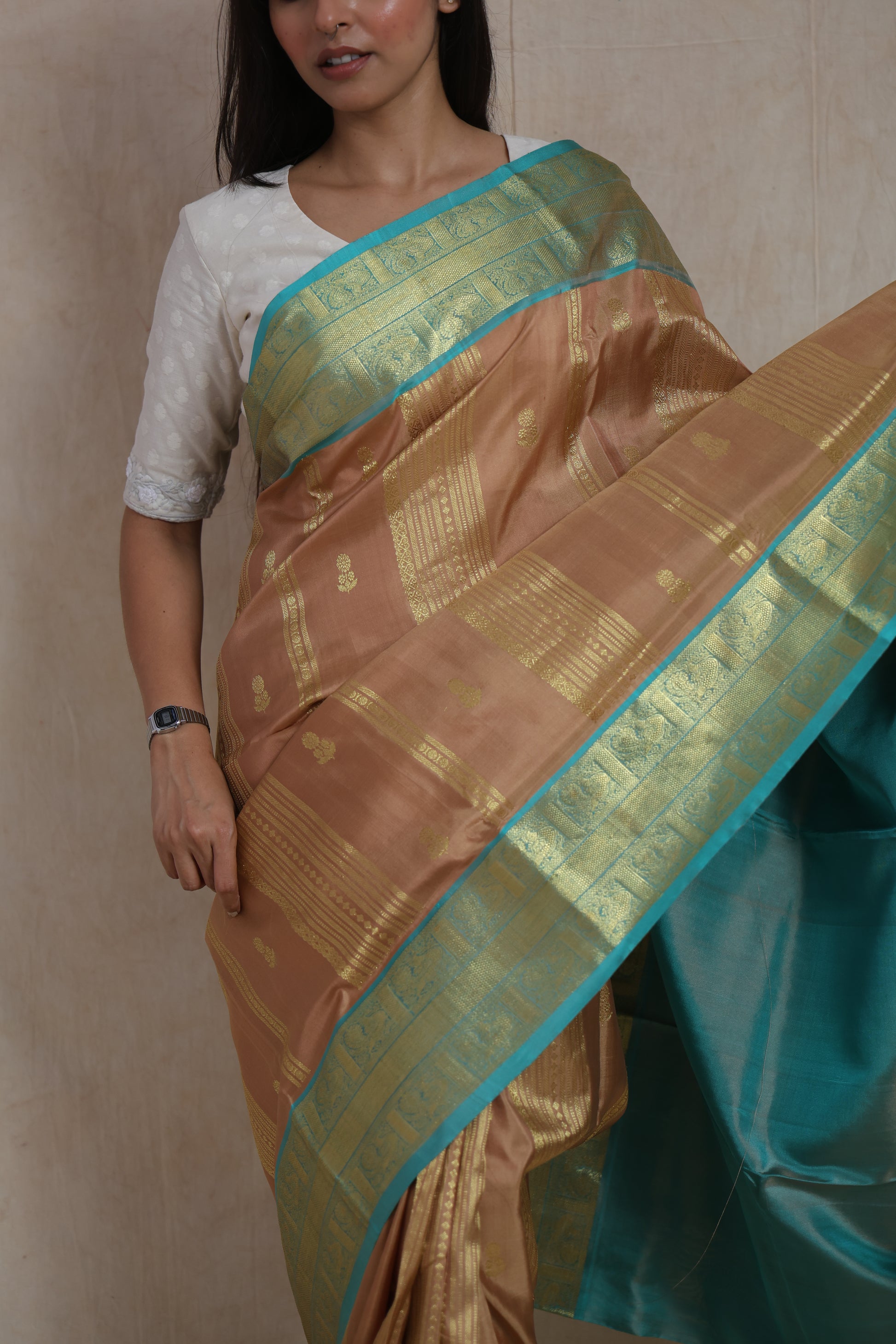 Close-up of Venkatagiri handloom silk saree featuring woven buttas, intricate border, and aqua blue contrast