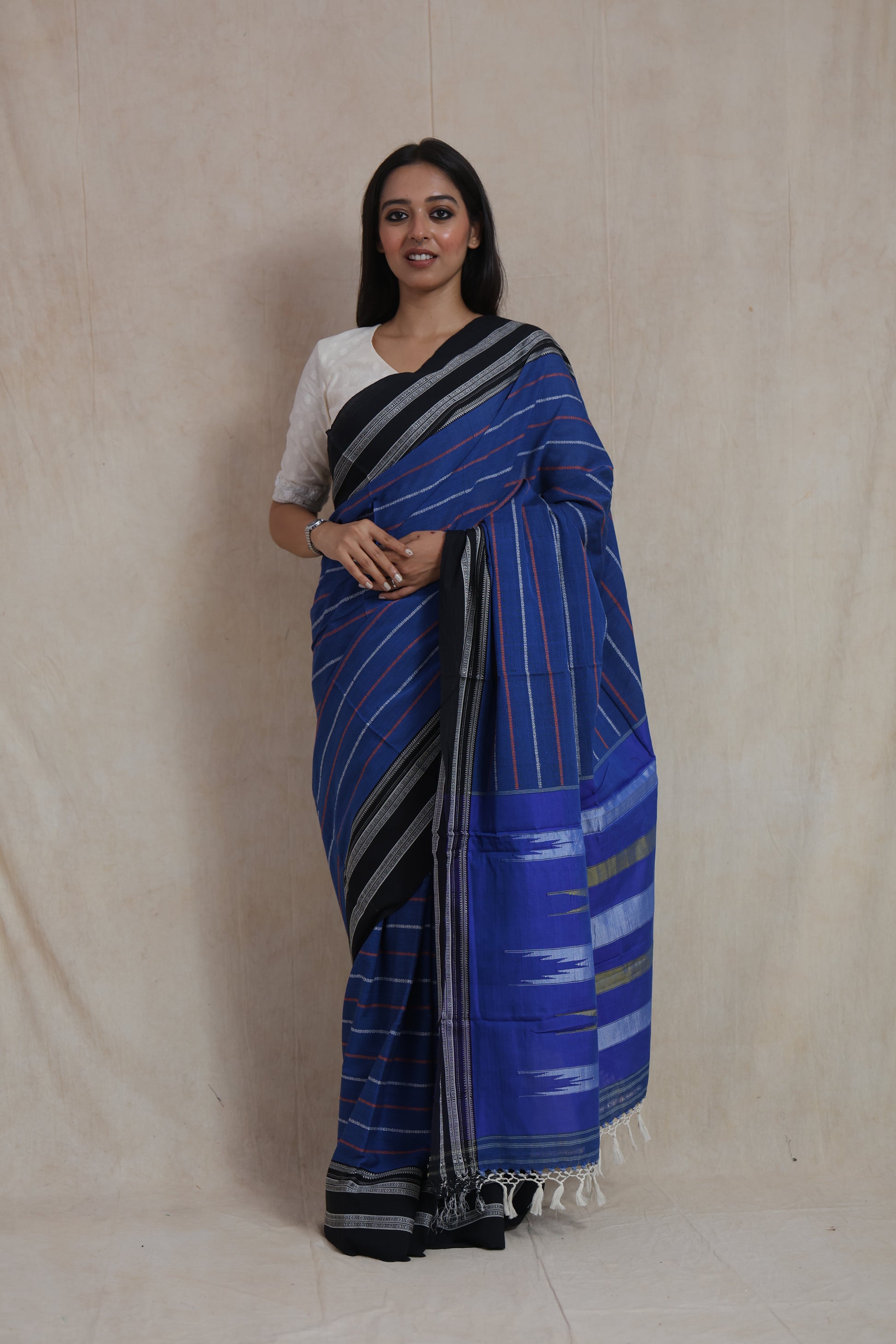 Model wearing royal blue and black Ilkal handloom cotton saree with striped woven design