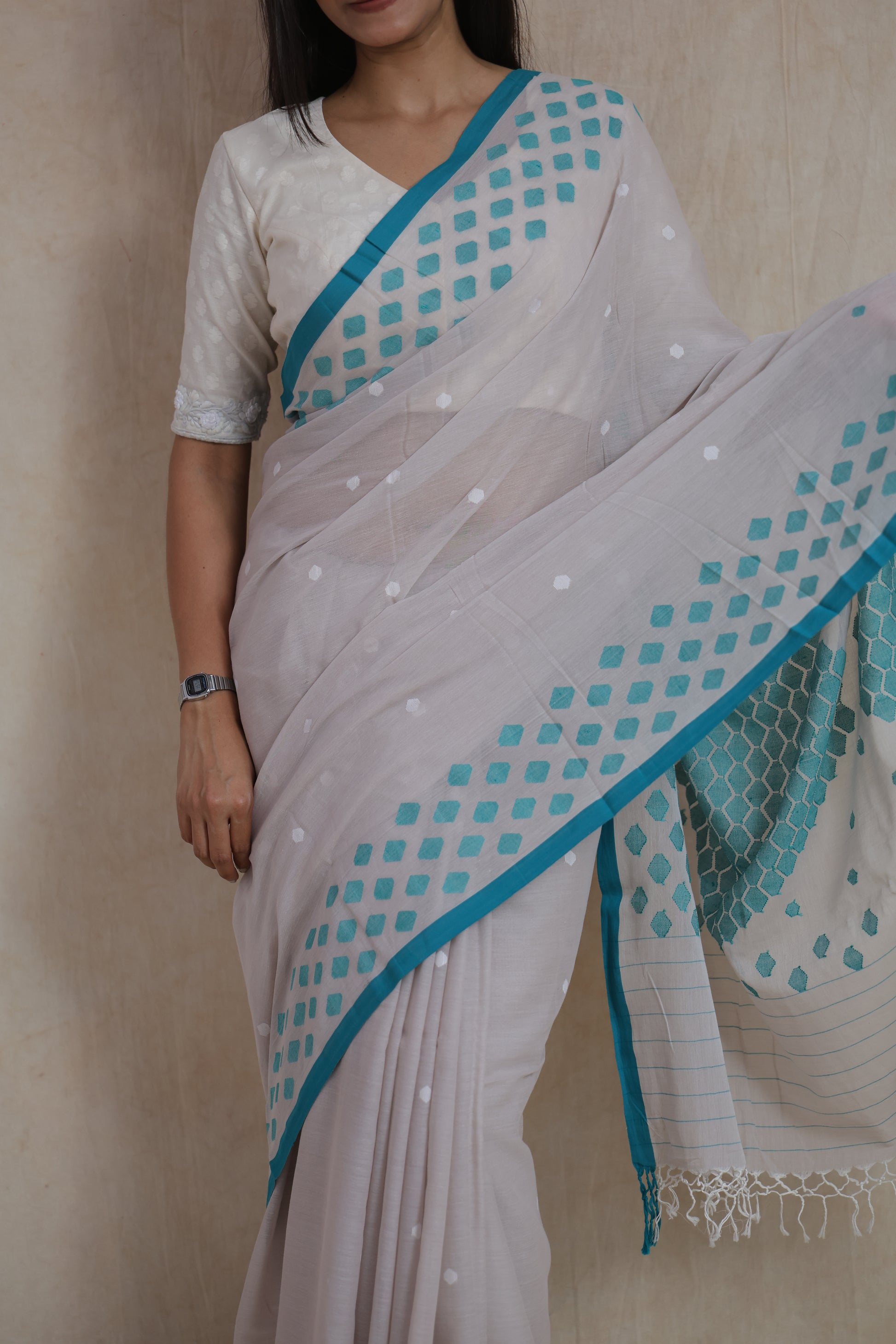Close-up of pearl grey Bengal Cotton Fulia saree with geometric woven border and delicate buttas