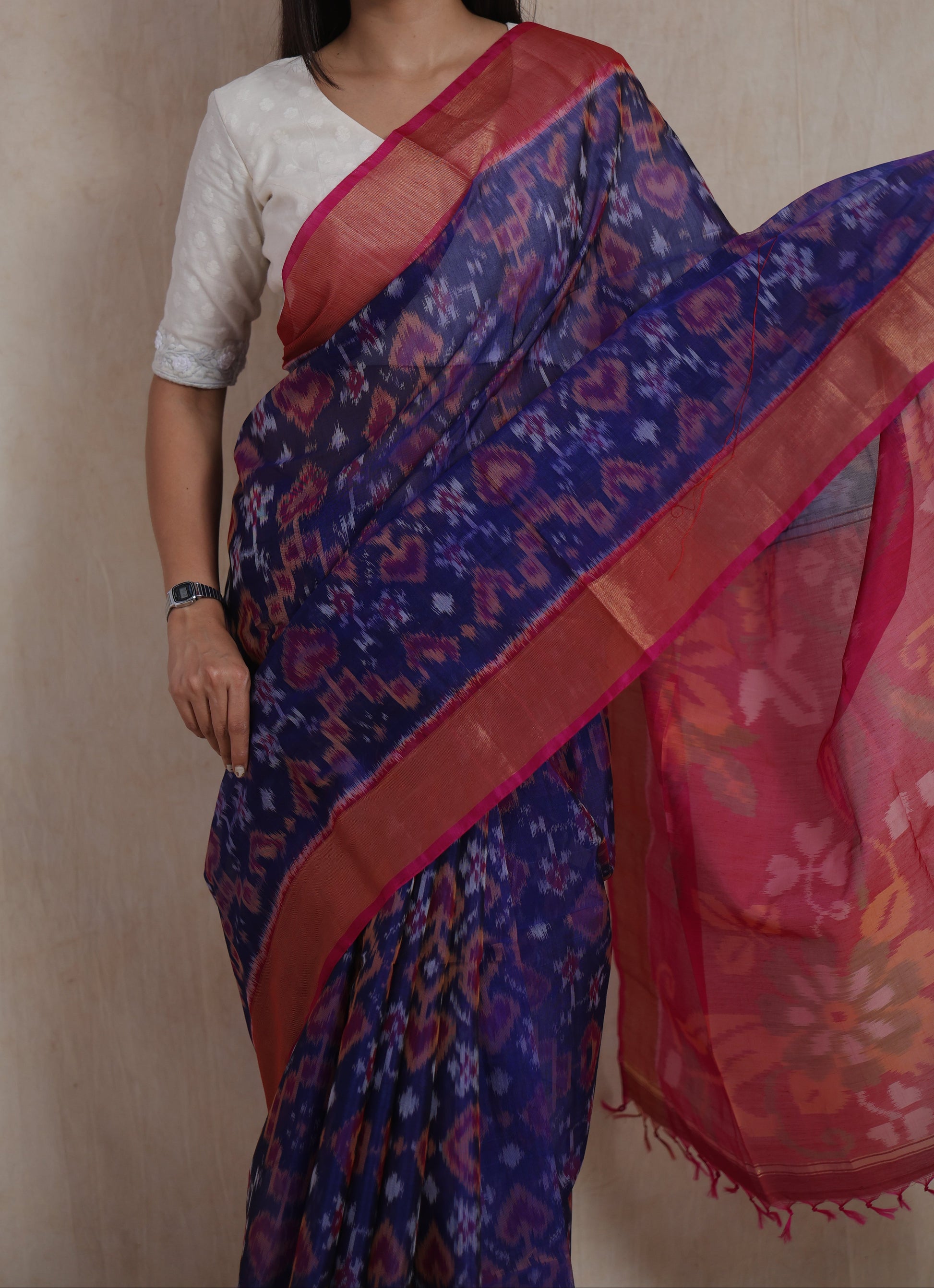 Close-up of indigo Panchampali silk cotton saree with traditional Ikat motifs and contrast pink border