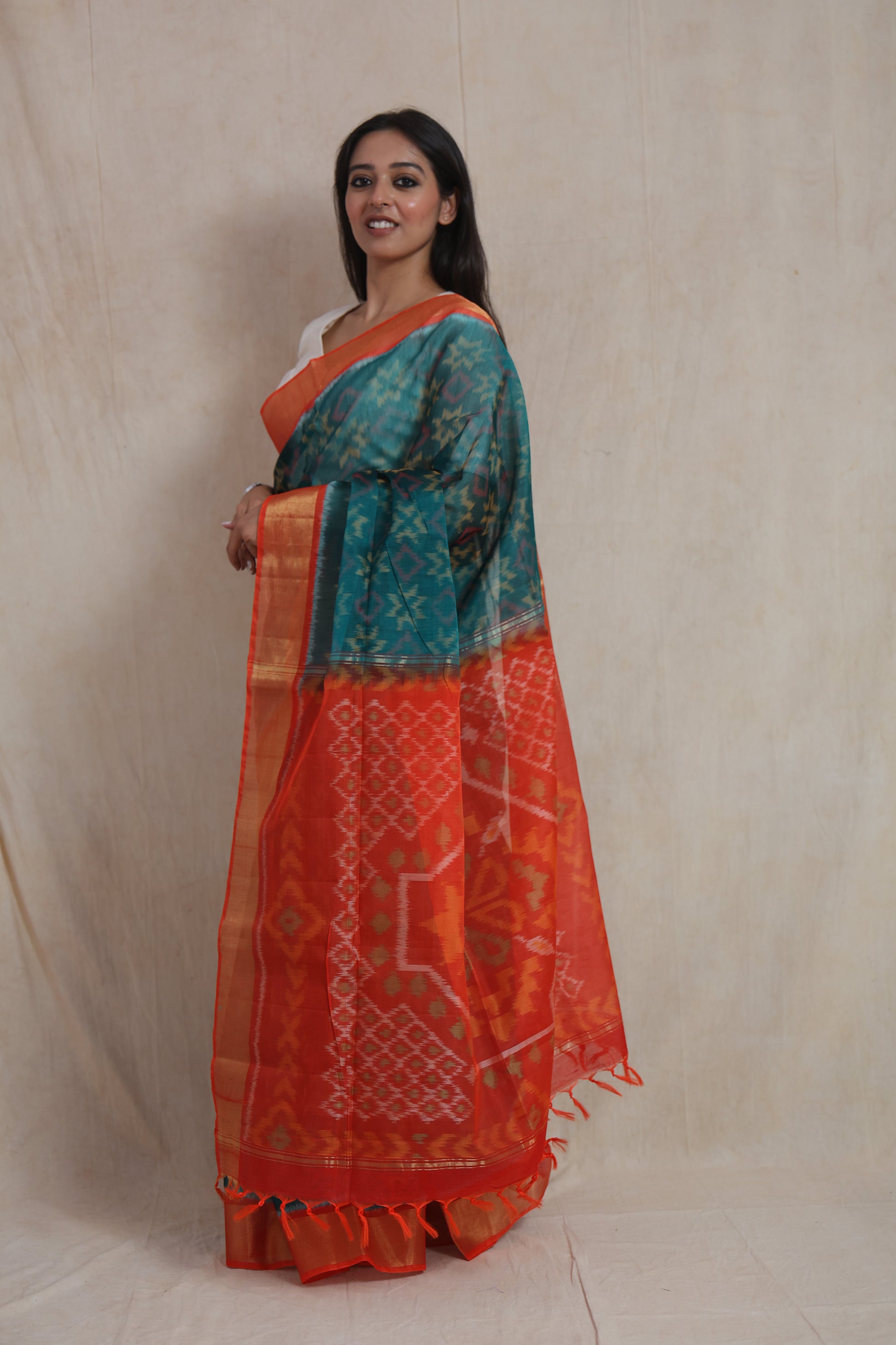 Side profile of Panchampali silk cotton saree showcasing vibrant orange pallu and ikat motifs