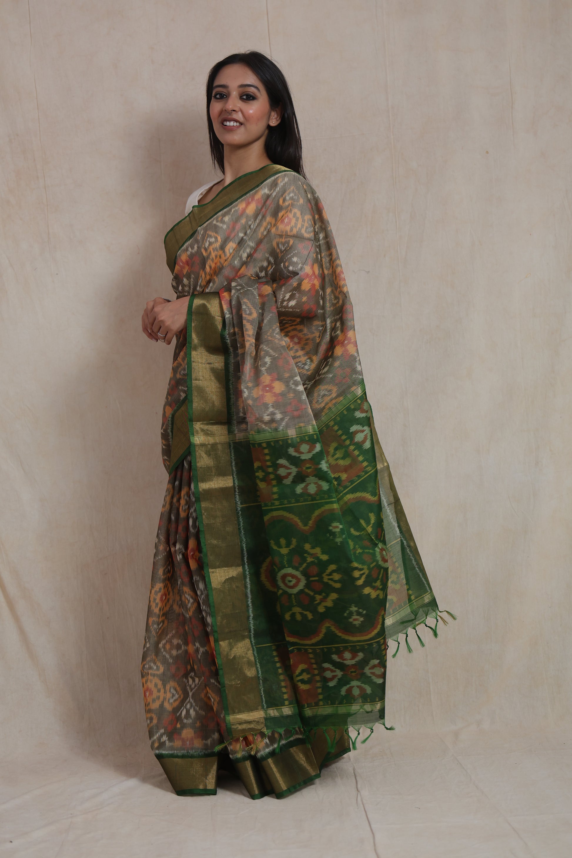 Side view of handwoven Panchampali silk cotton saree featuring emerald green floral pallu and traditional Ikat motifs