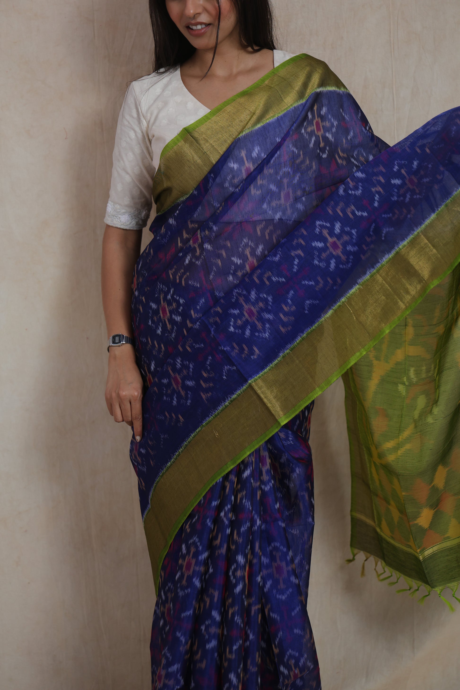 Close-up of royal indigo Pochampally silk cotton saree featuring intricate Ikat motifs and golden border