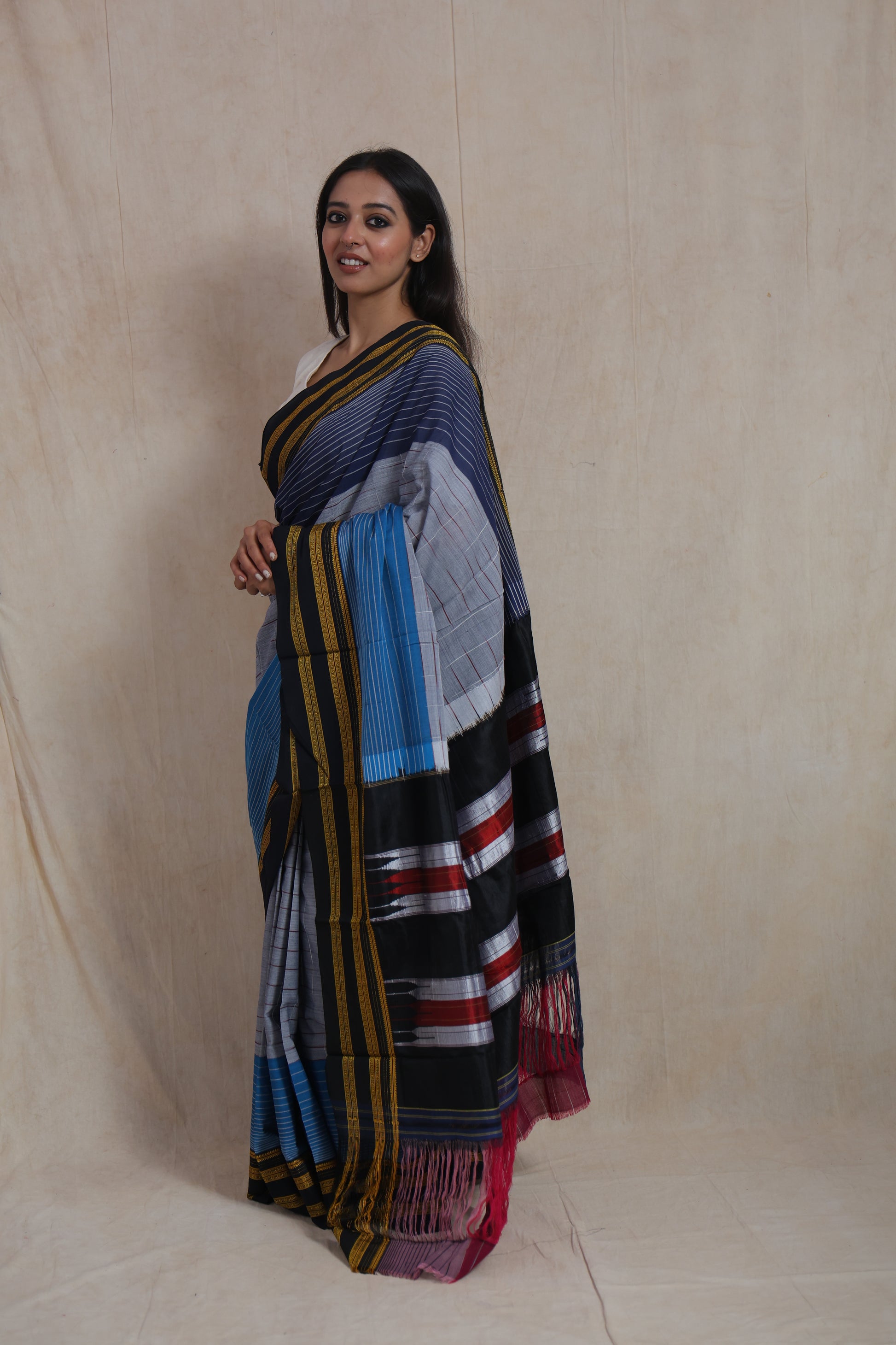 Side profile of Ilkal handloom cotton saree showcasing signature pallu and striped border design