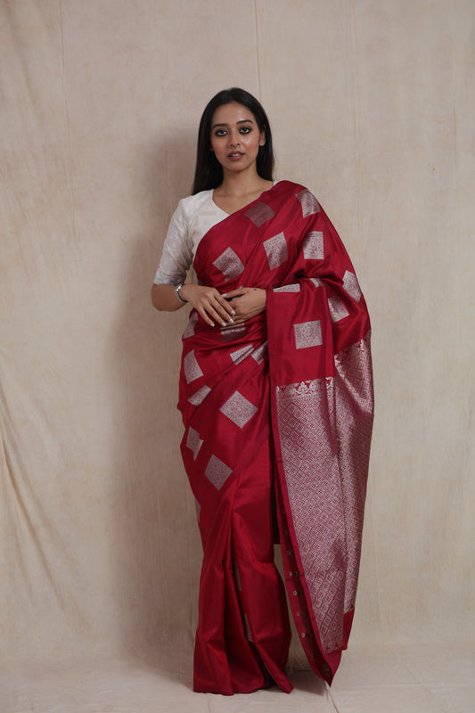 Front view of a crimson red Venkatgiri silk saree featuring silver woven buttas, elegant border, and rich pallu.